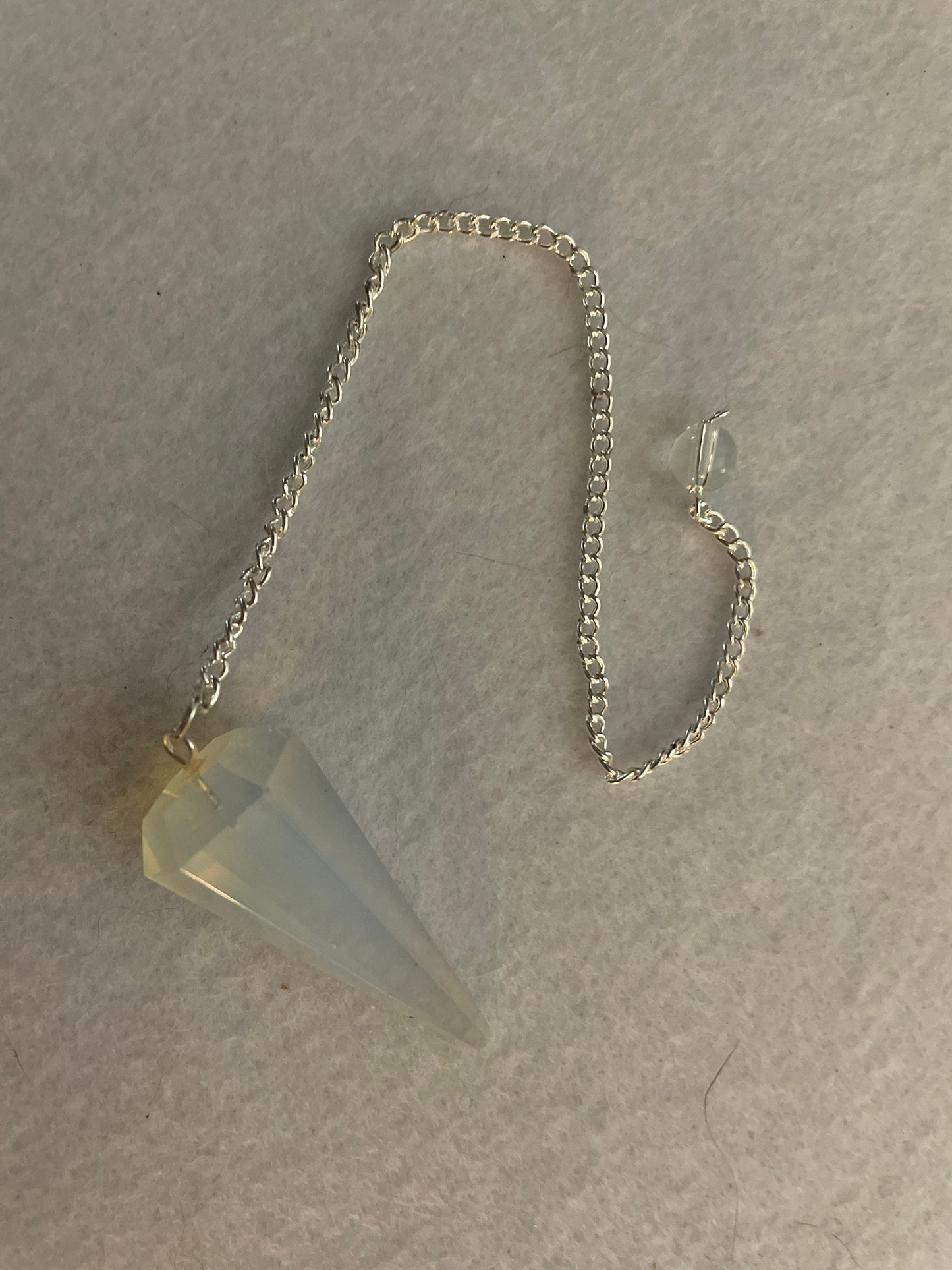 This beautiful  Opalite pendulum is approximately 1.65” and with chain is 8.5”