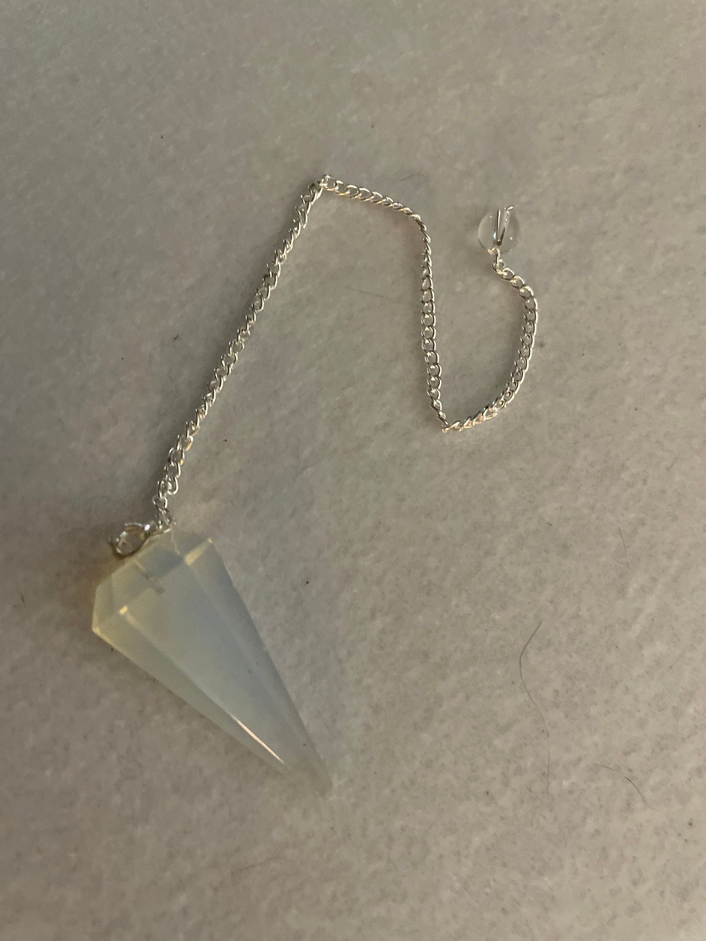 This beautiful  Opalite pendulum is approximately 1.65” and with chain is 8.5”