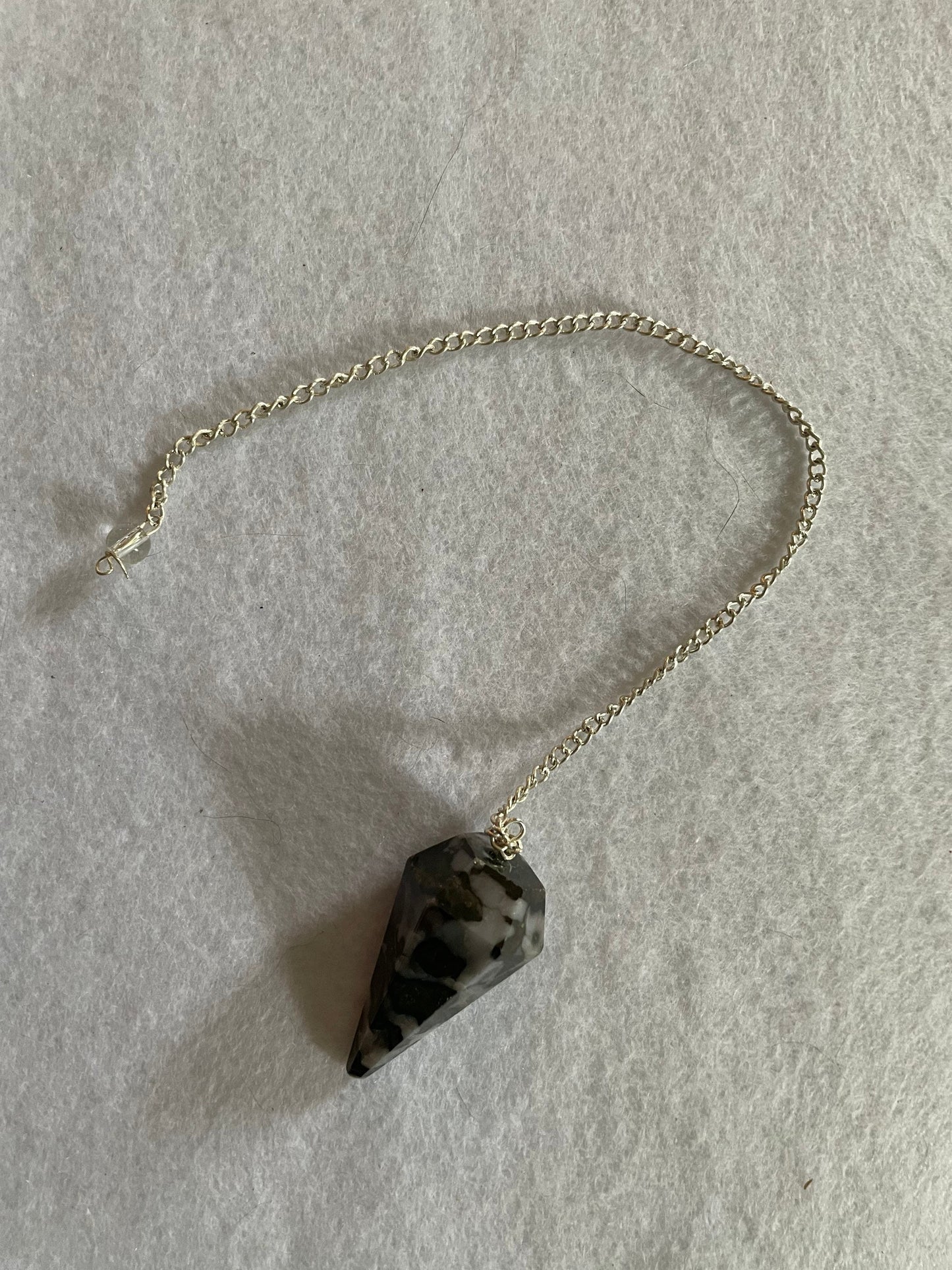 This beautiful Gabbro pendulum is approximately 1.5” and with chain is 9.5” total length.