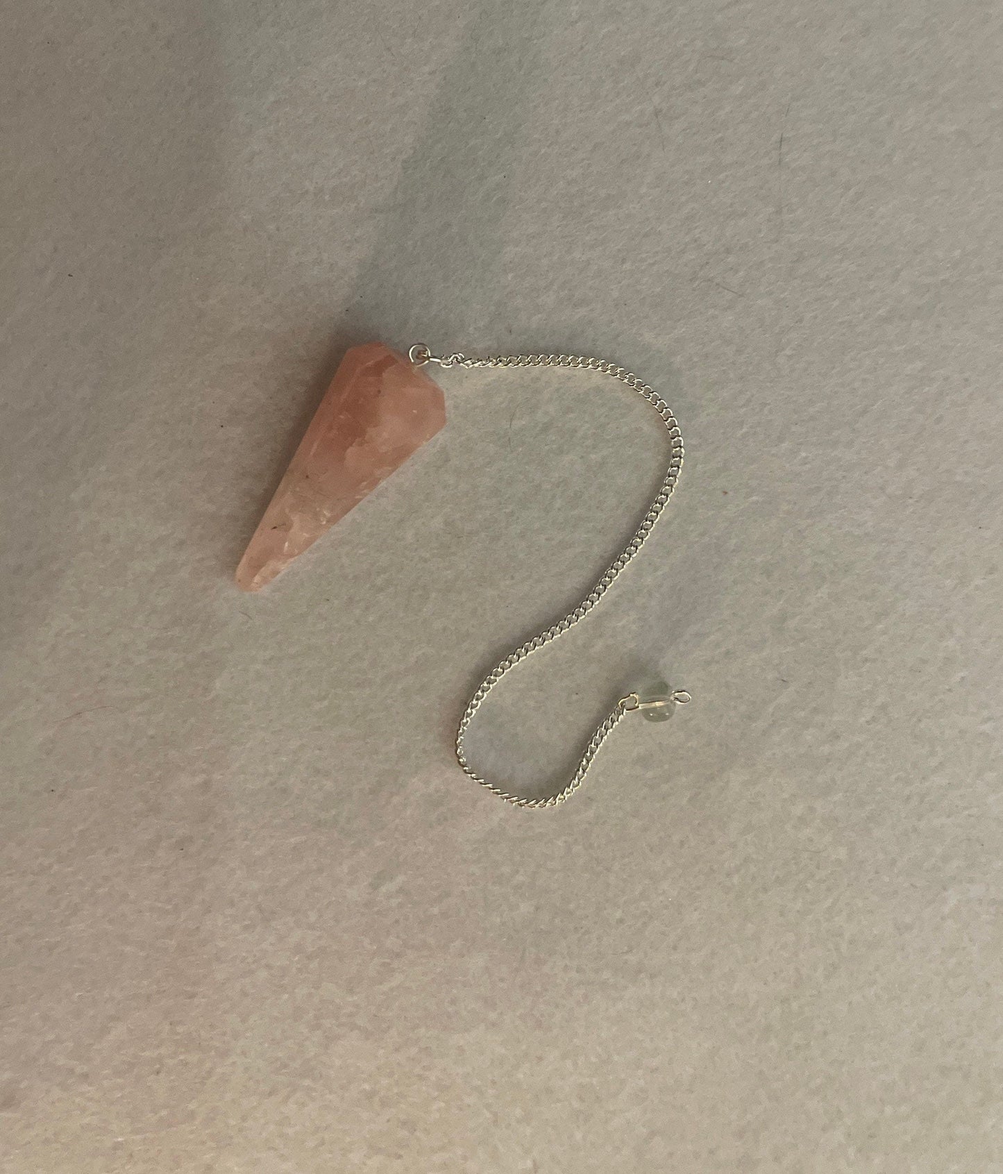 This beautiful Rose Quartz Pendulum is 1.85” and with chain is 8.25”