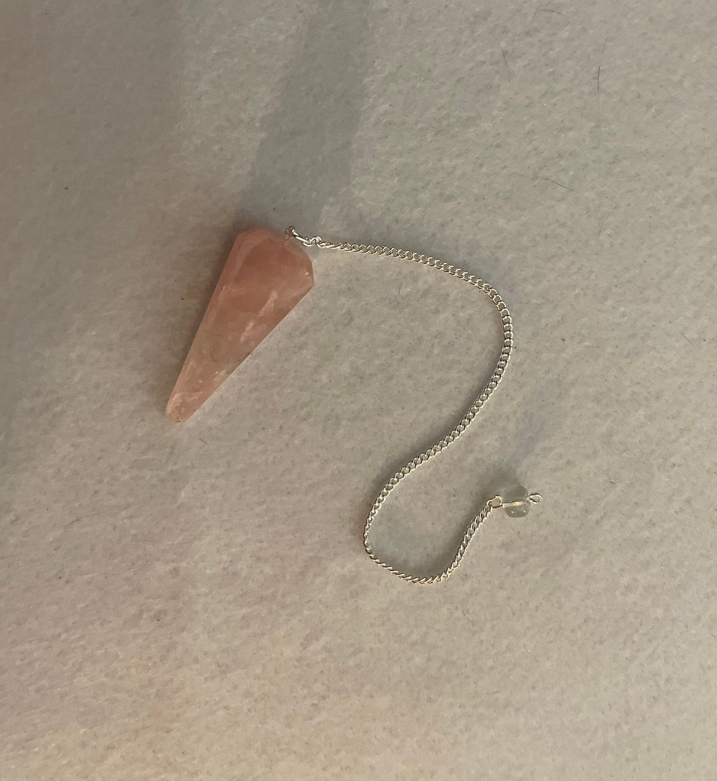 This beautiful Rose Quartz Pendulum is 1.85” and with chain is 8.25”