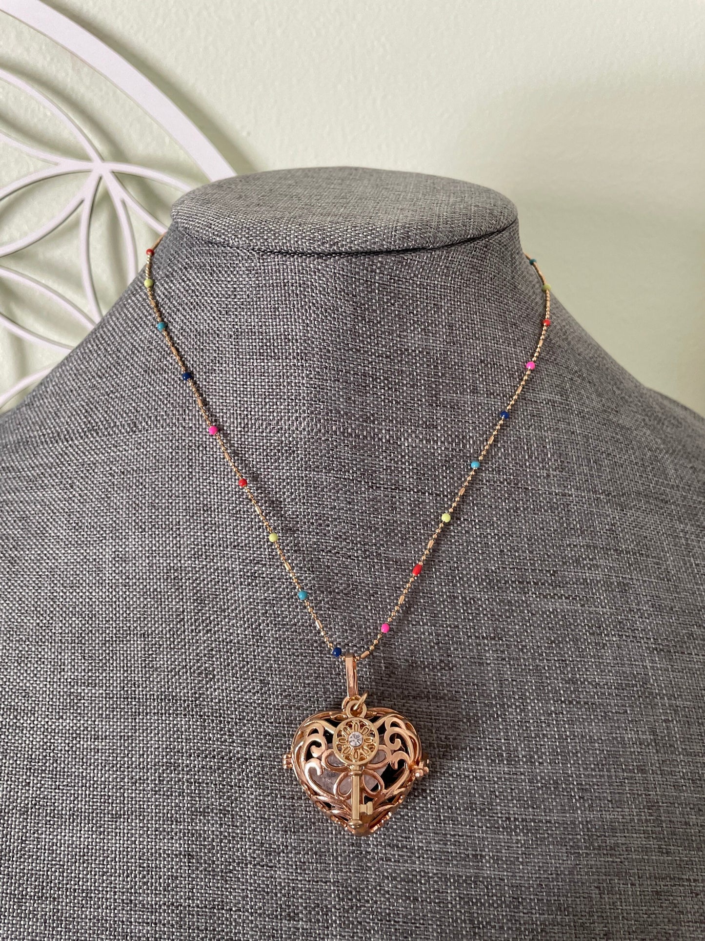 Gold locket filled with crystals on 16+” beaded gold