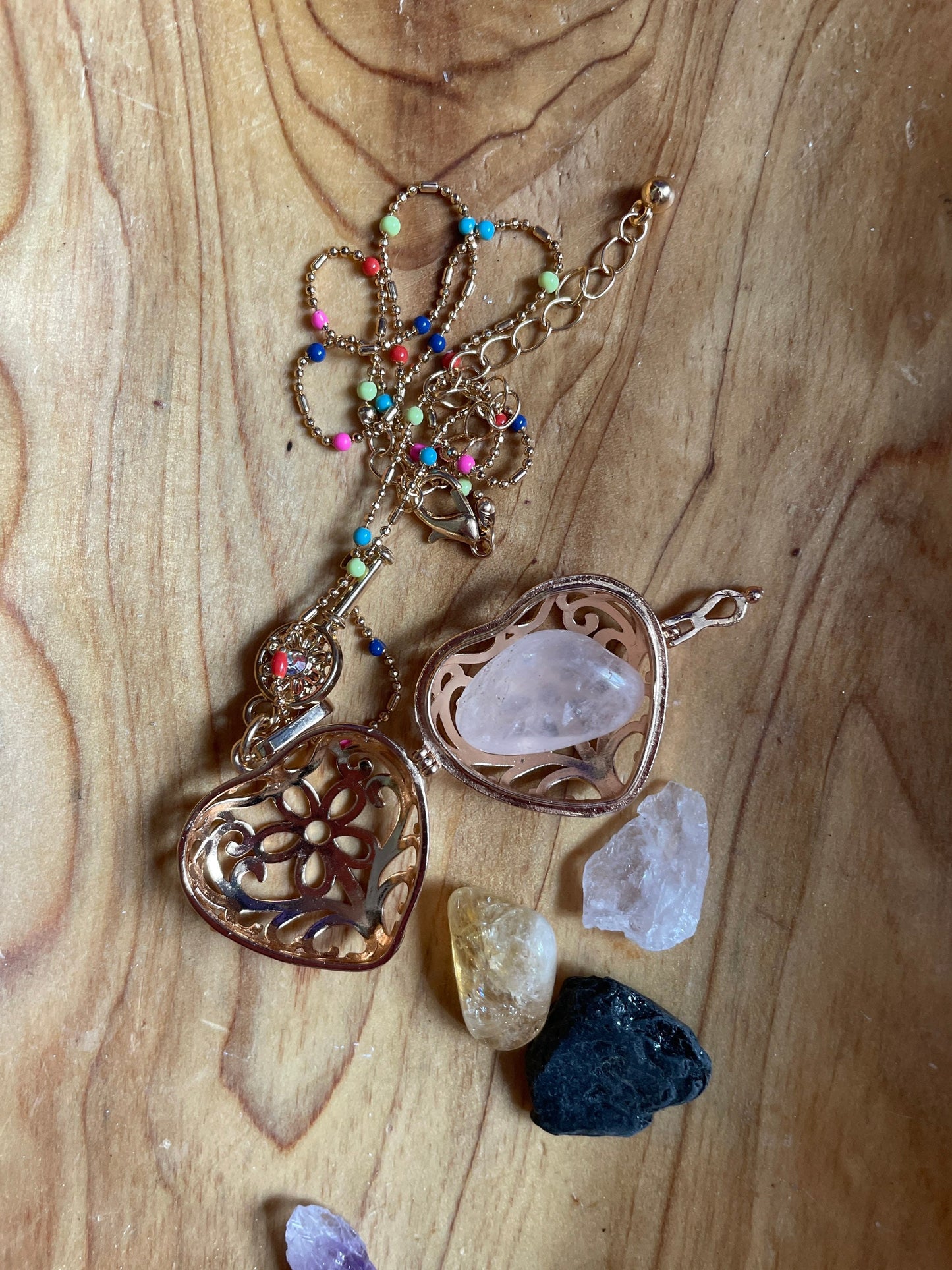 Gold locket filled with crystals on 16+” beaded gold