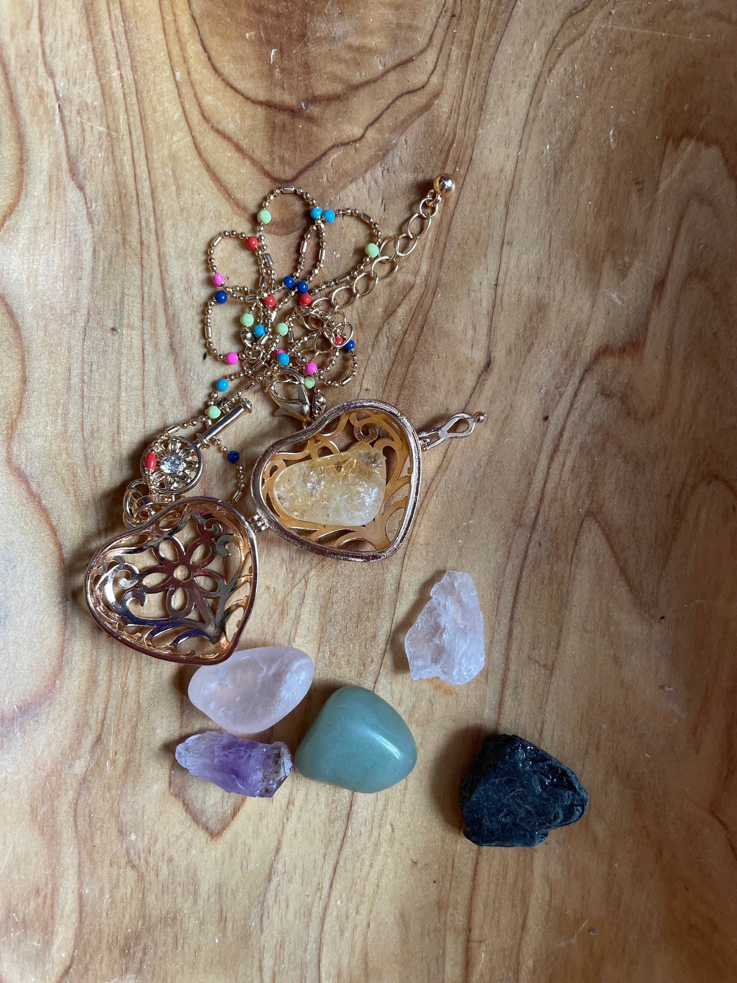 Gold locket filled with crystals on 16+” beaded gold