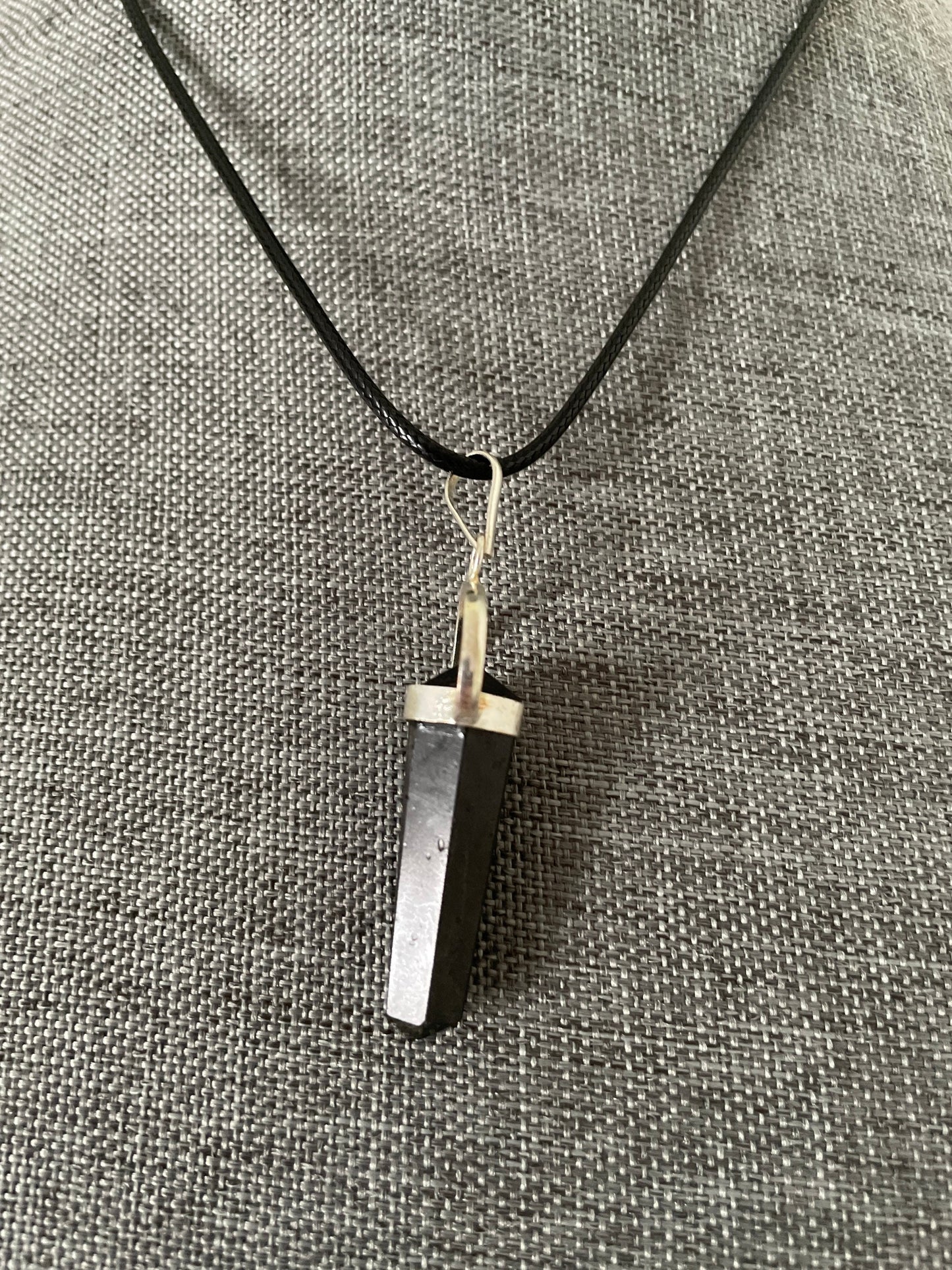 Beautiful black obsidian pendant on a black cord attached with silver wire