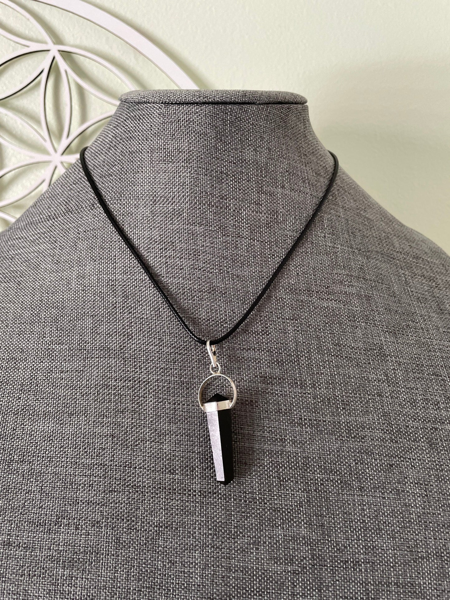 Beautiful black obsidian pendant on a black cord attached with silver wire