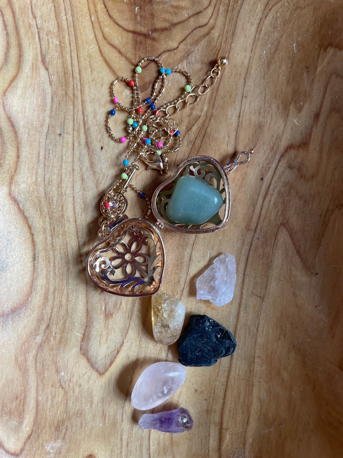 Gold locket filled with crystals on 16+” beaded gold