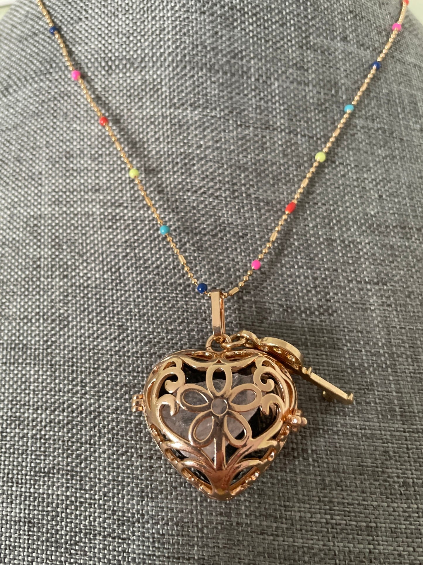 Gold locket filled with crystals on 16+” beaded gold