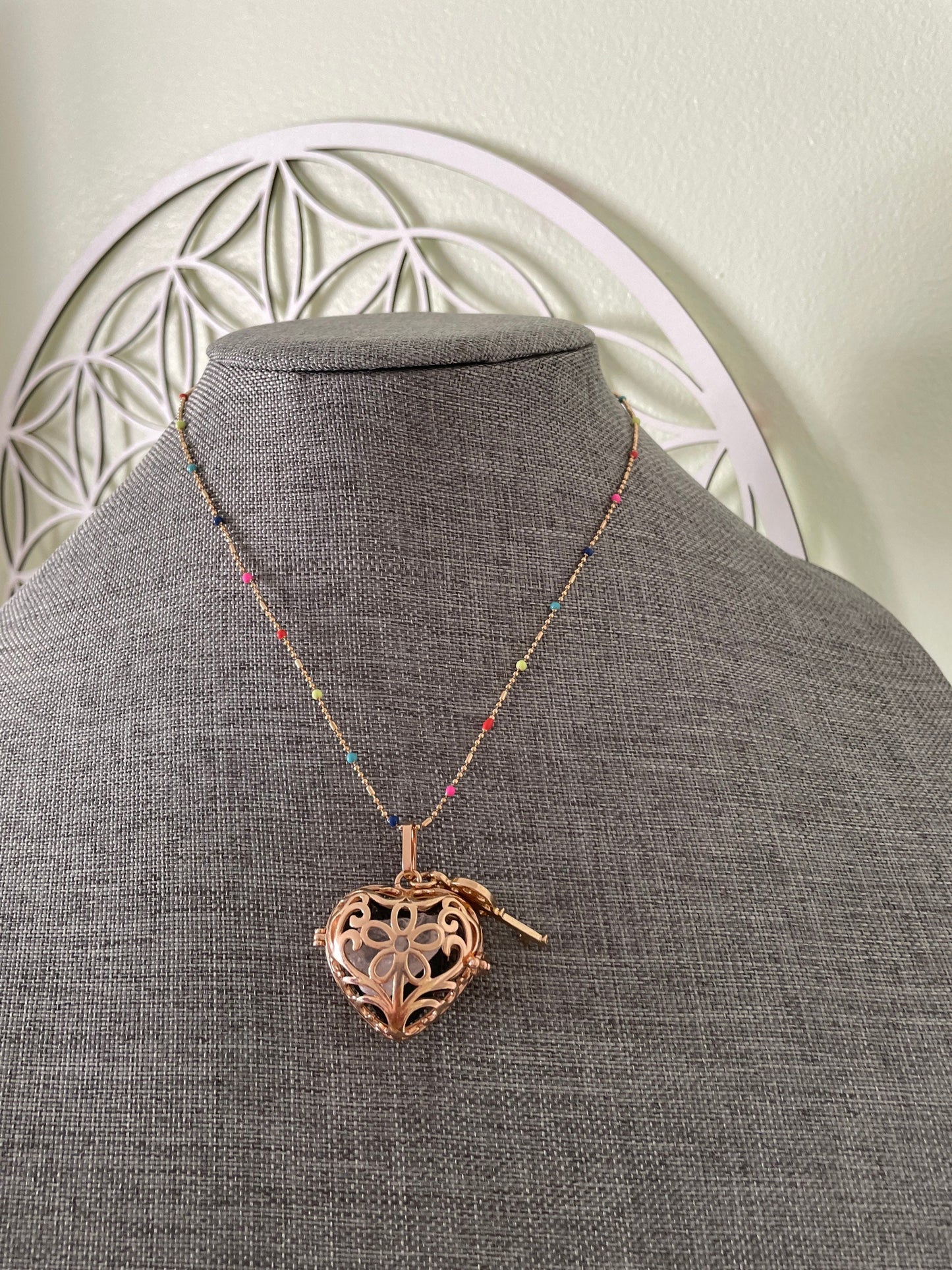 Gold locket filled with crystals on 16+” beaded gold