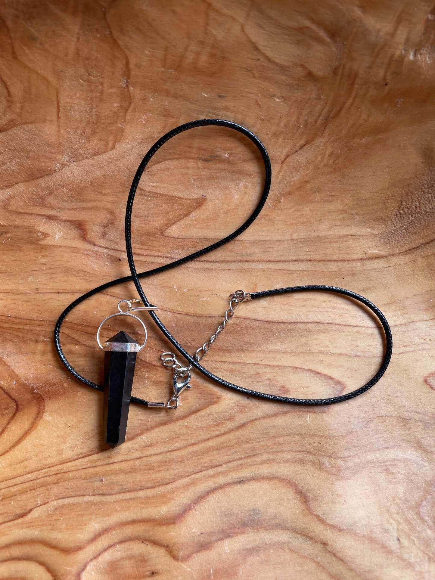 Beautiful black obsidian point pendant necklace wrapped in silver on a black nylon cord