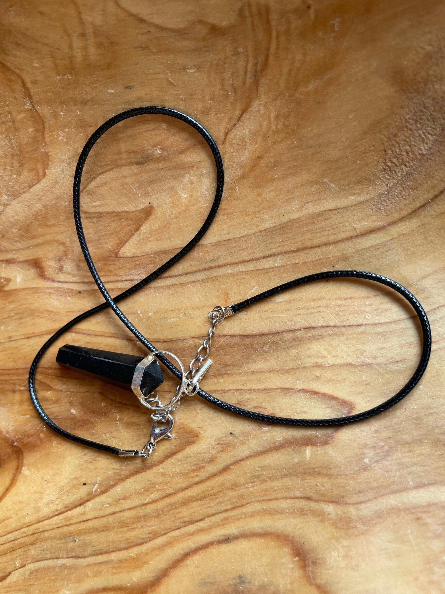 Beautiful black obsidian point pendant necklace wrapped in silver on a black nylon cord