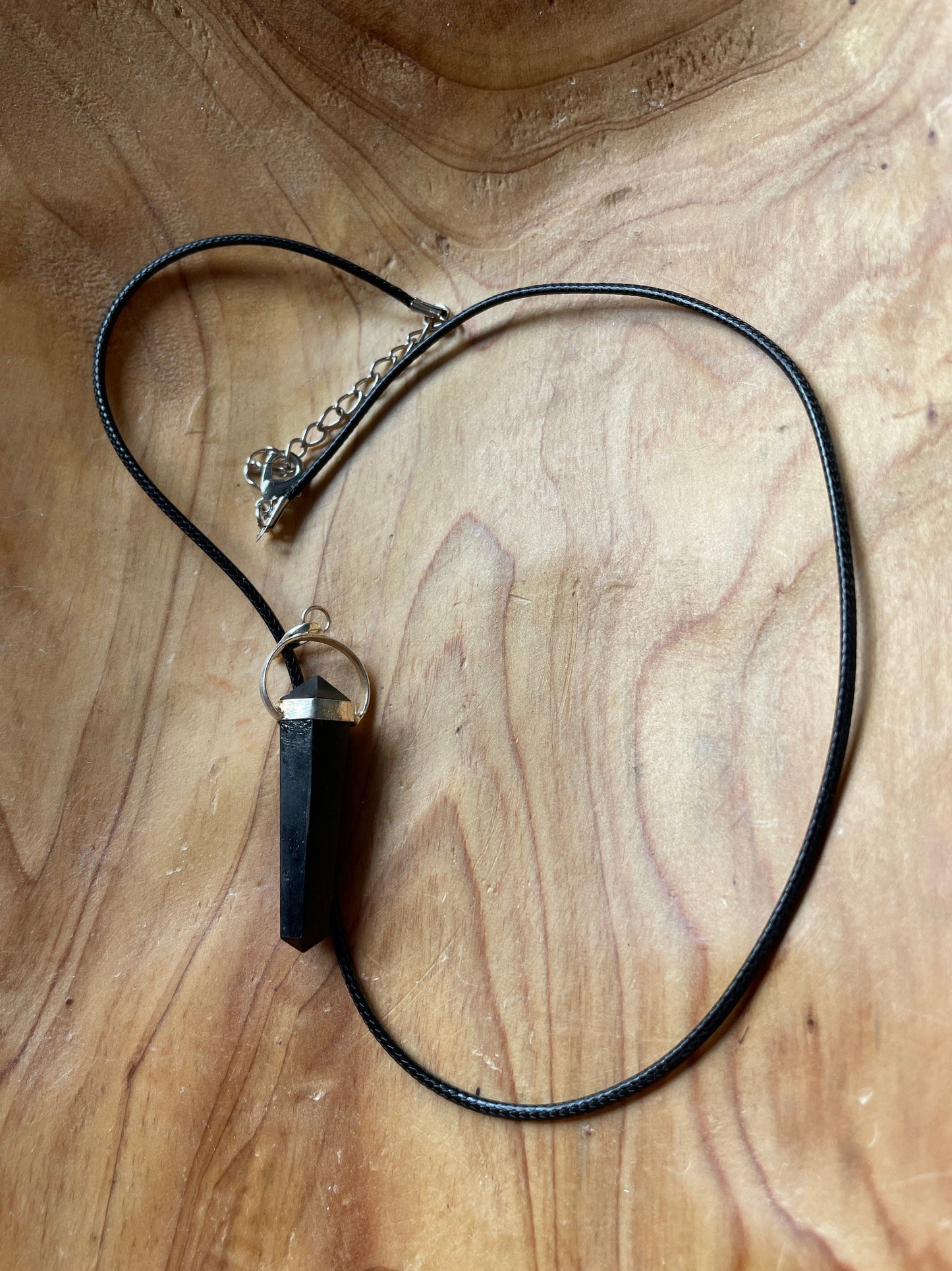 Beautiful black obsidian point pendant necklace wrapped in silver on a black nylon cord