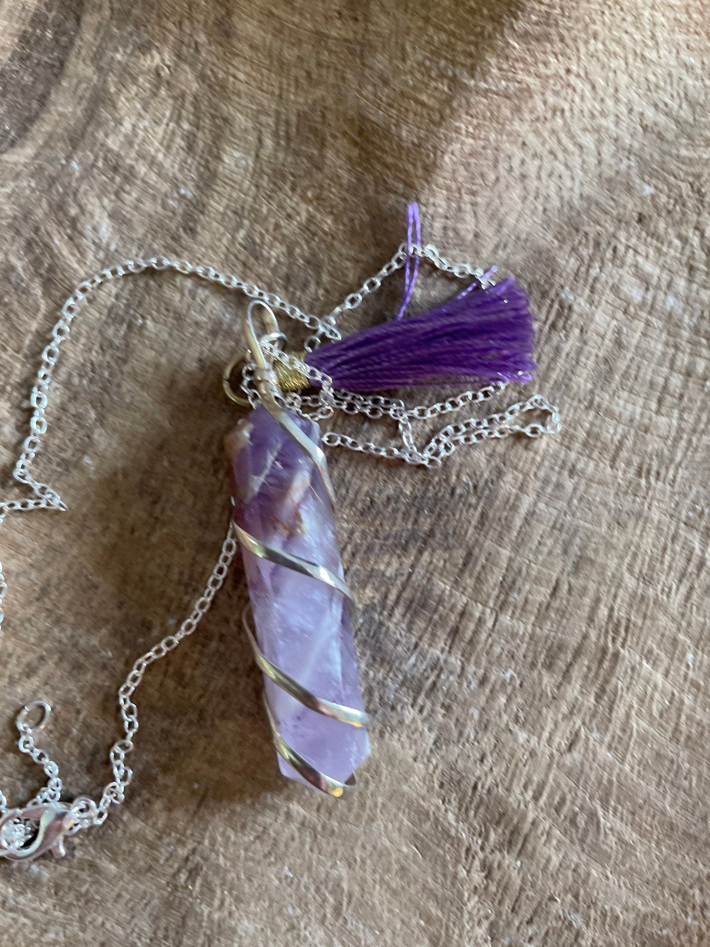 Gorgeous Banded Amethyst double Point Pendant is 2” and is attached to precious silver making the total length almost 2.25” with purple Pom