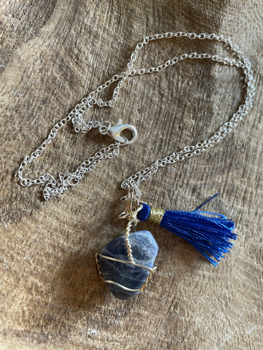 Pretty tumbled Sodalite is wrapped in silver wire is approximately .85” and is attached to a precious silver-plated chain making 16+” chain