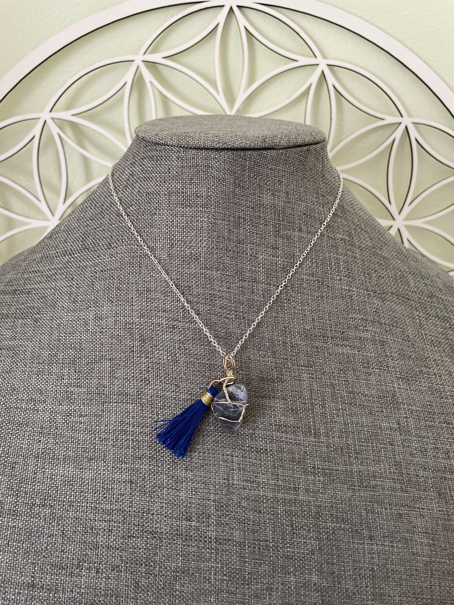 Pretty tumbled Sodalite is wrapped in silver wire is approximately .85” and is attached to a precious silver-plated chain making 16+” chain