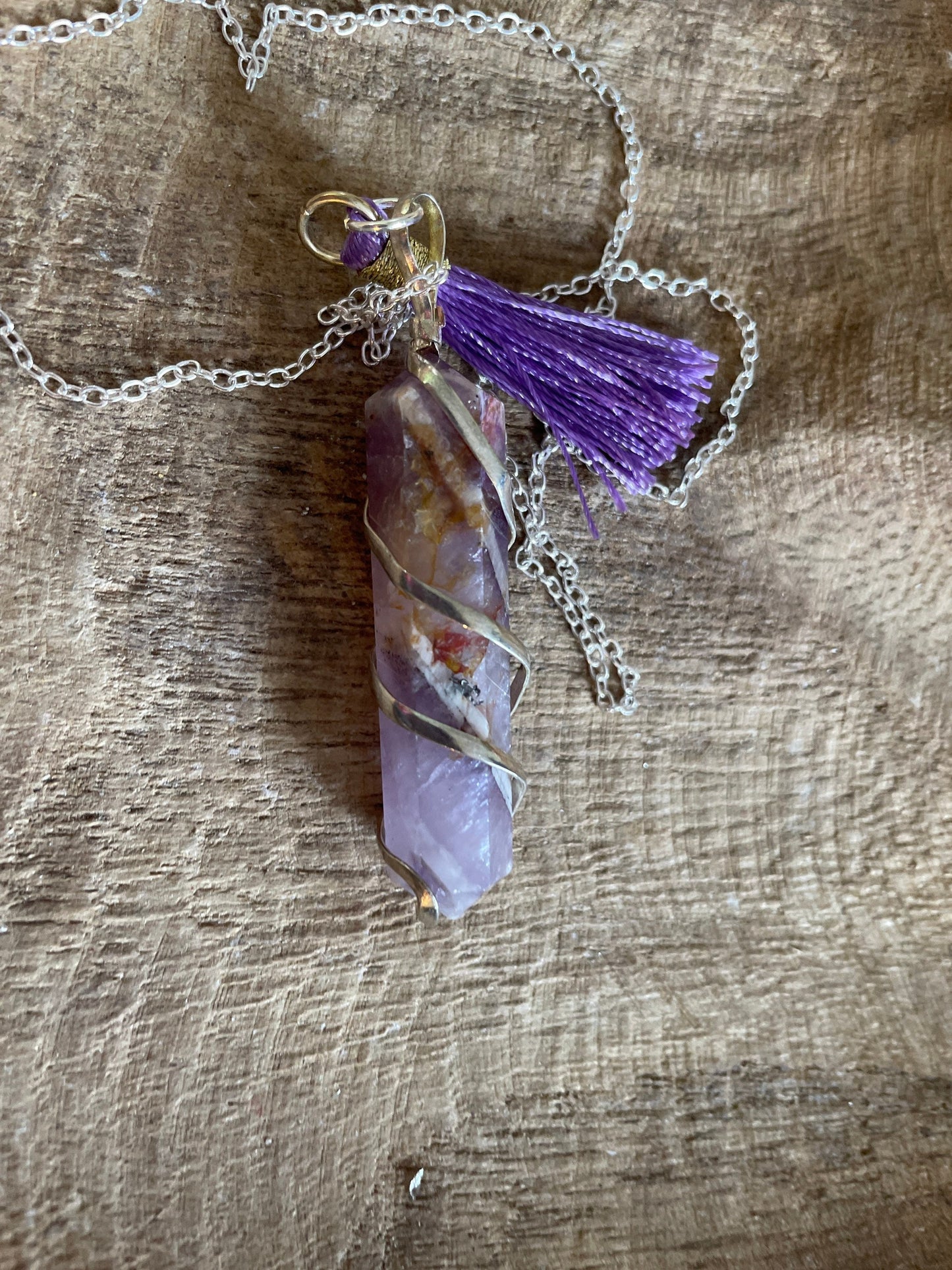 Gorgeous Banded Amethyst double Point Pendant is 2” and is attached to precious silver making the total length almost 2.25” with purple Pom