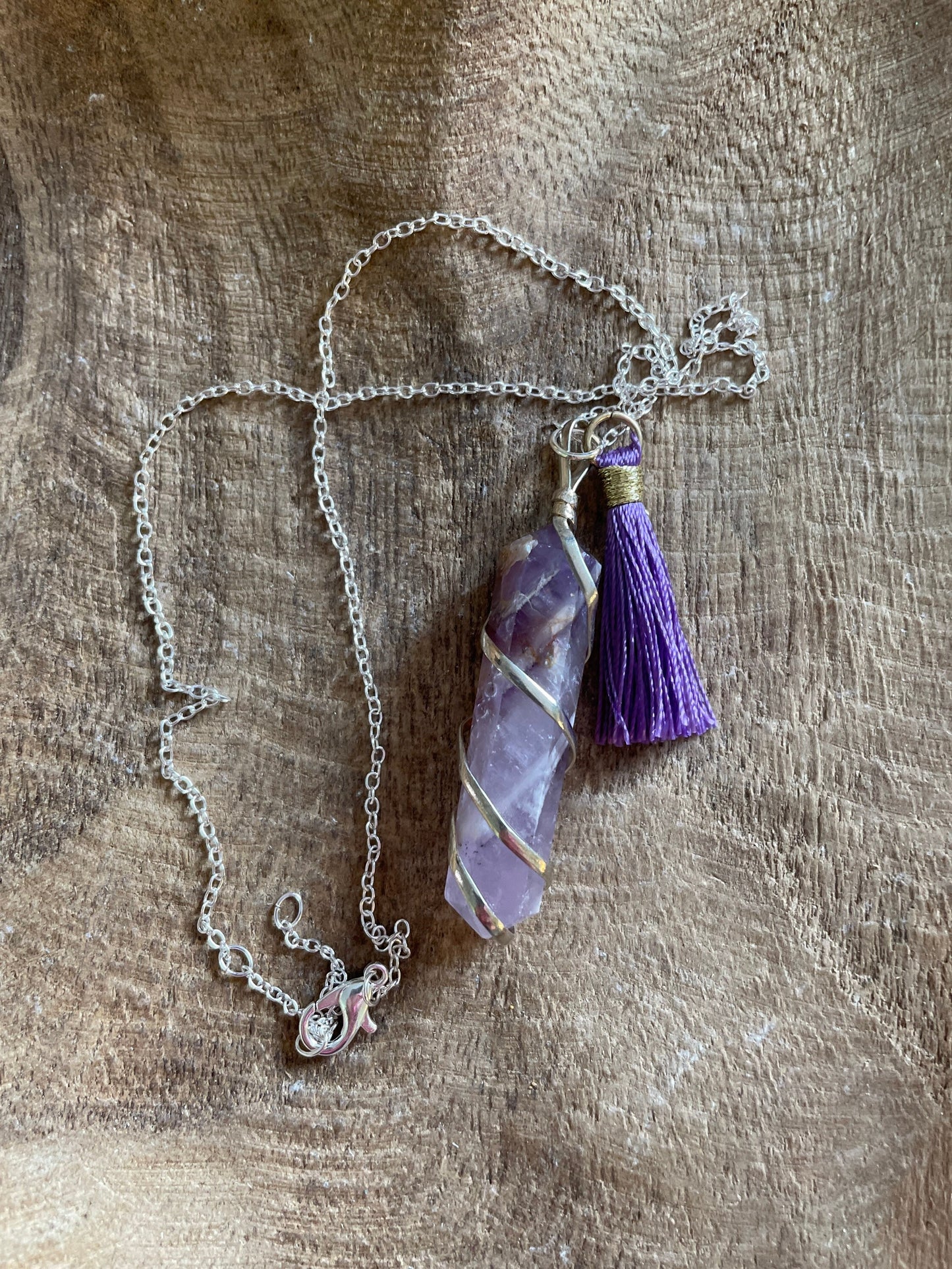 Gorgeous Banded Amethyst double Point Pendant is 2” and is attached to precious silver making the total length almost 2.25” with purple Pom