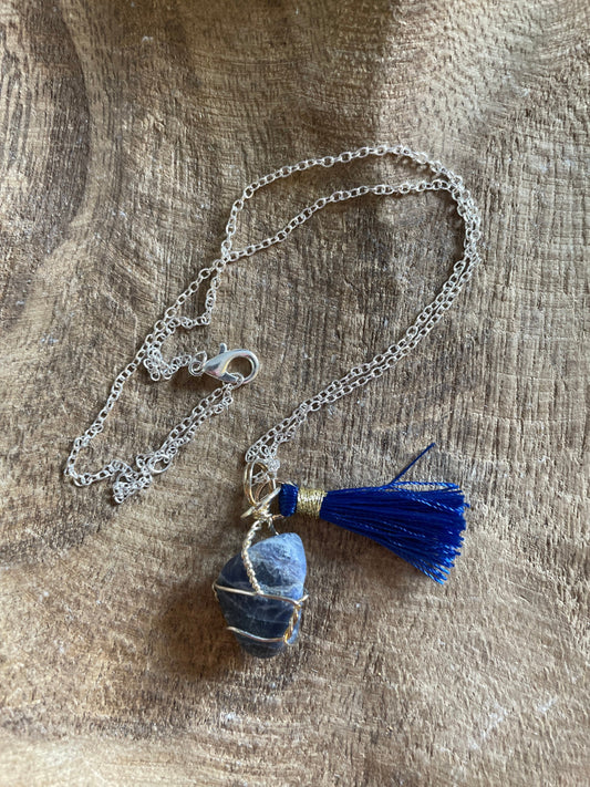 Pretty tumbled Sodalite is wrapped in silver wire is approximately .85” and is attached to a precious silver-plated chain making 16+” chain