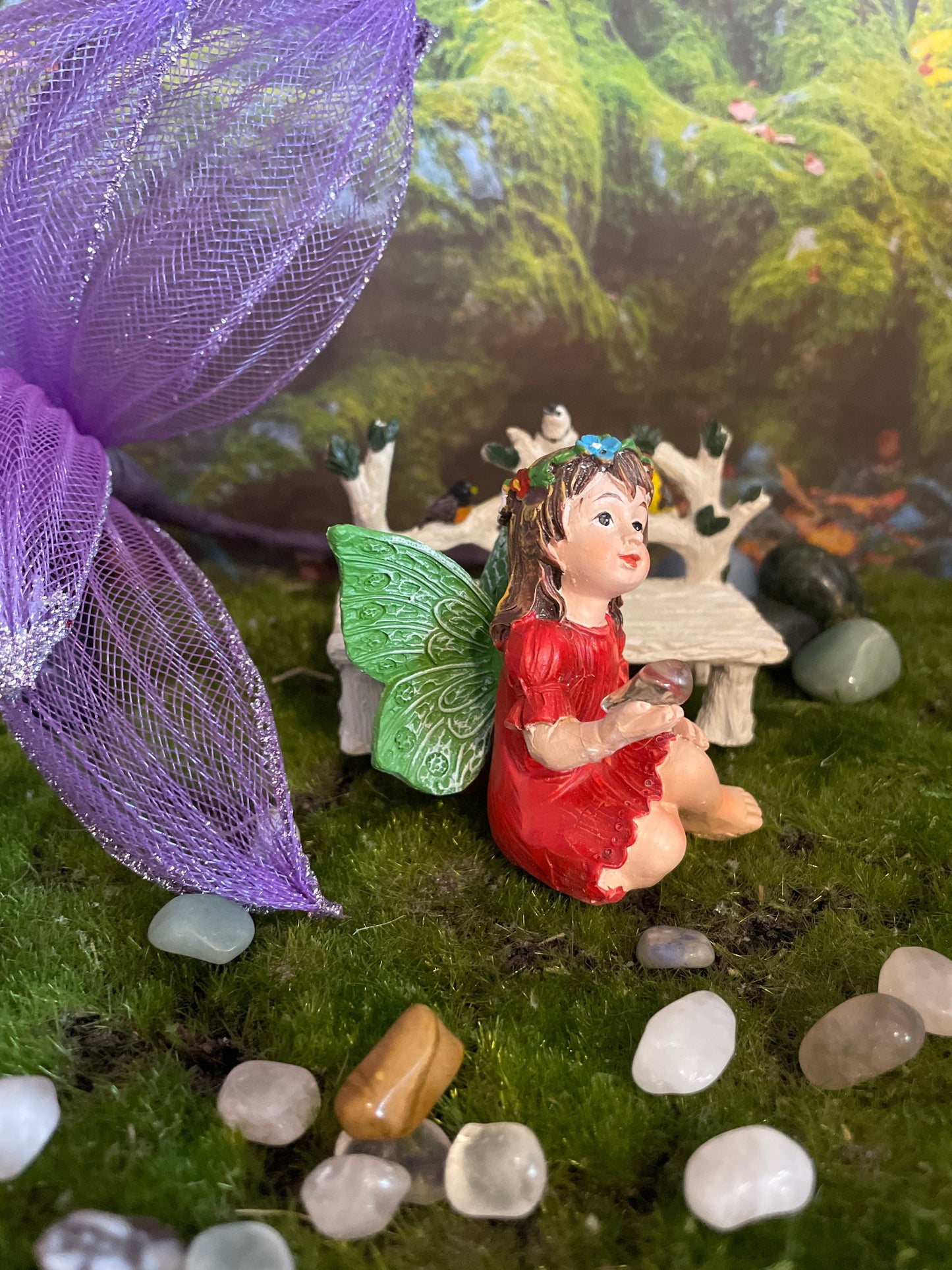 Look at her sweet face and she’s holding a clear quartz crystal hand-painted fairy with crystals