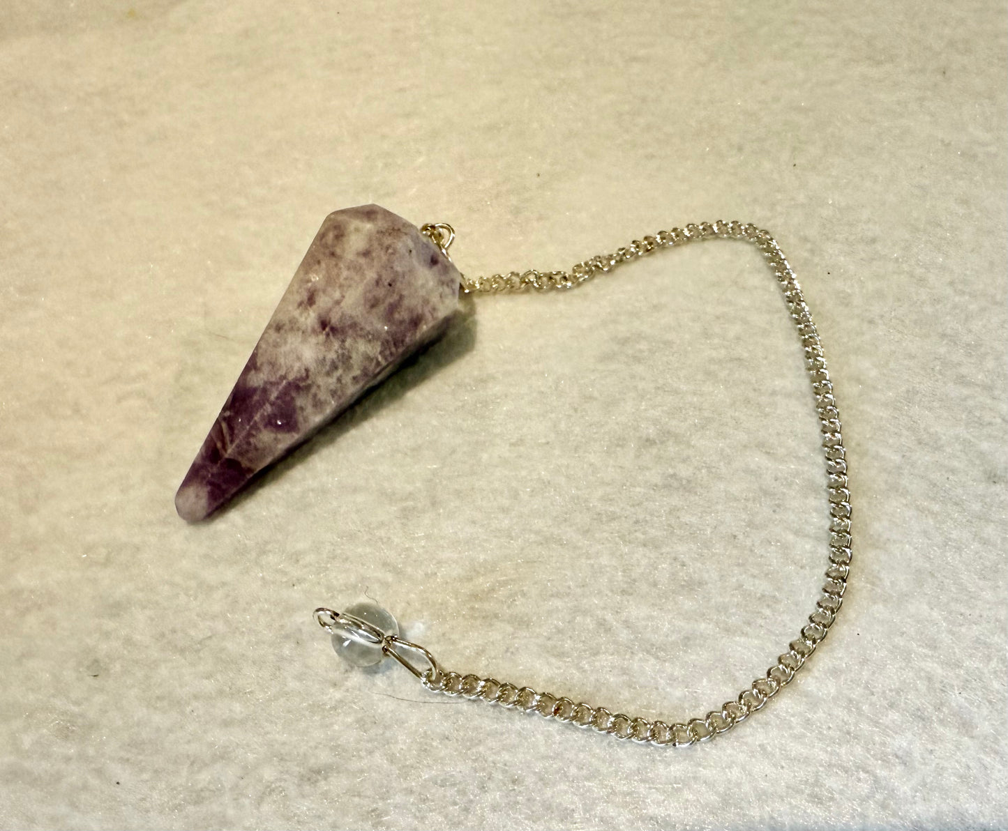 Beautiful Lepidolite Pendulum is  1.65” and with chain is 8.75”.