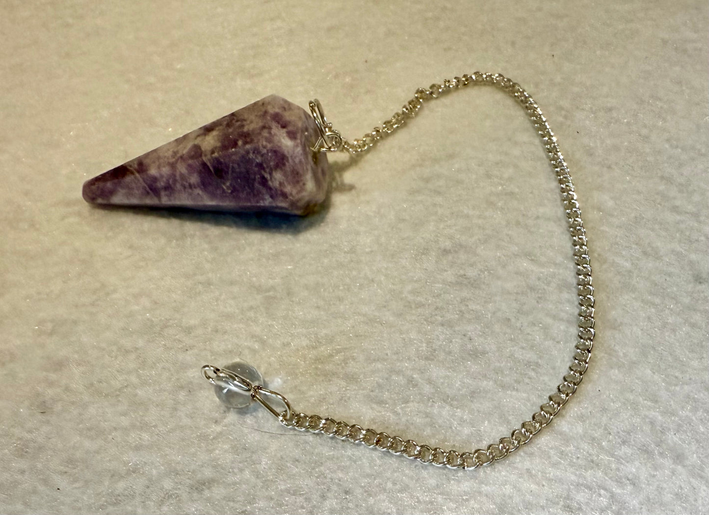 Beautiful Lepidolite Pendulum is  1.65” and with chain is 8.75”.