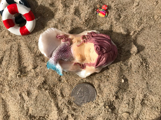 Fairy garden mermaid nestled sweetly in a shell