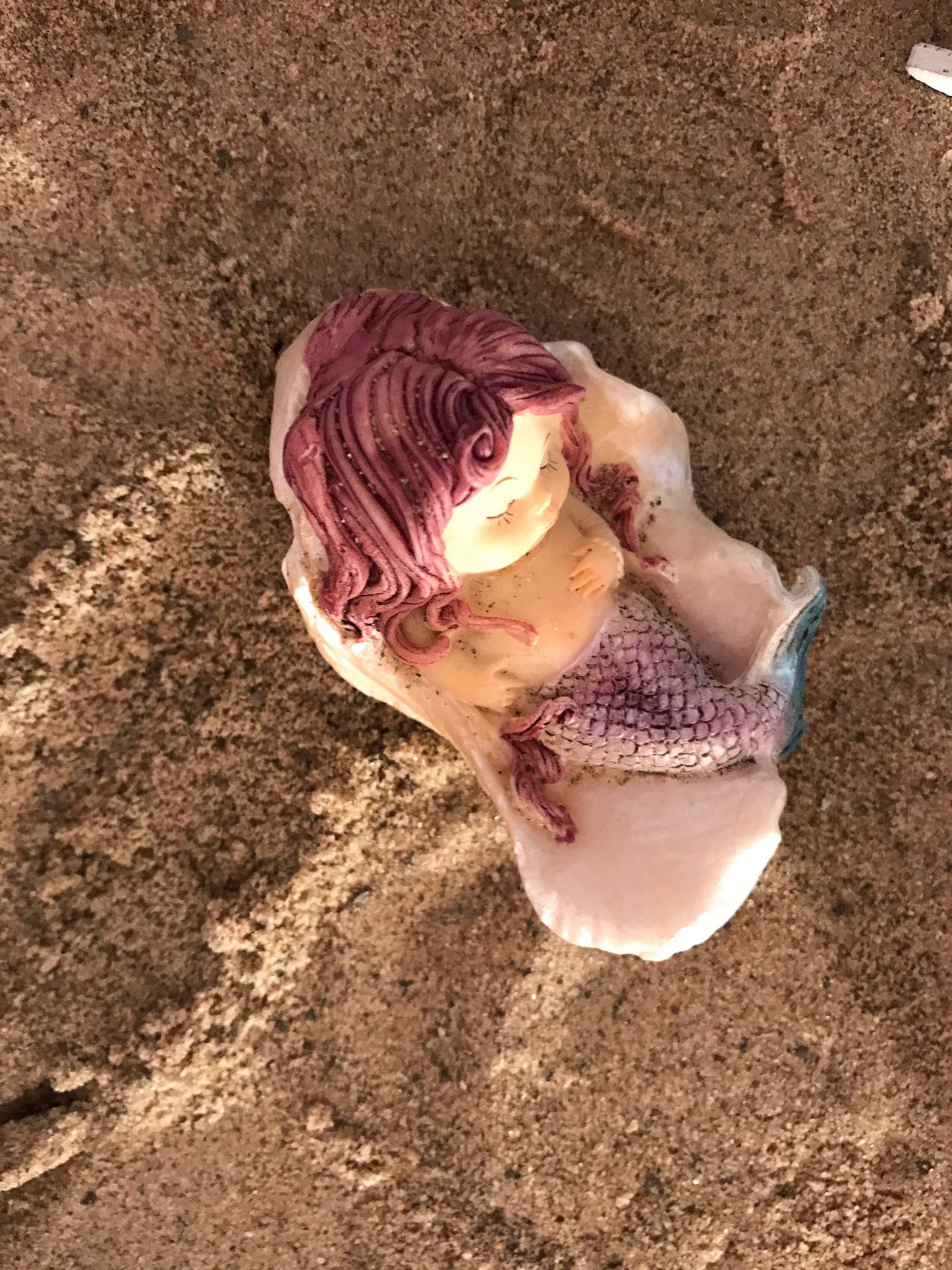 Fairy garden mermaid nestled sweetly in a shell