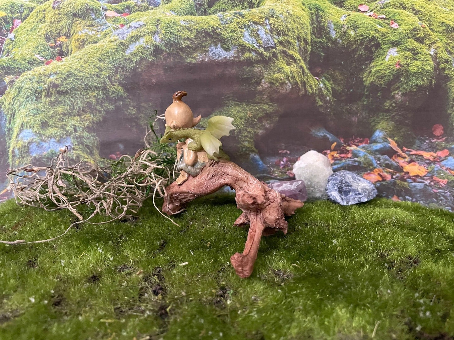 Pixie lovers garden pixie and baby green dragon perching on a log