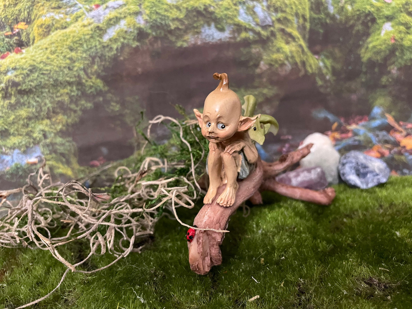 Pixie lovers garden pixie and baby green dragon perching on a log