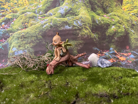 Pixie lovers garden pixie and baby green dragon perching on a log