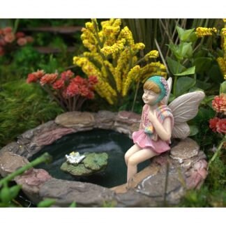 Sweet fairy figurine sitting in swimming suit and ready for summer