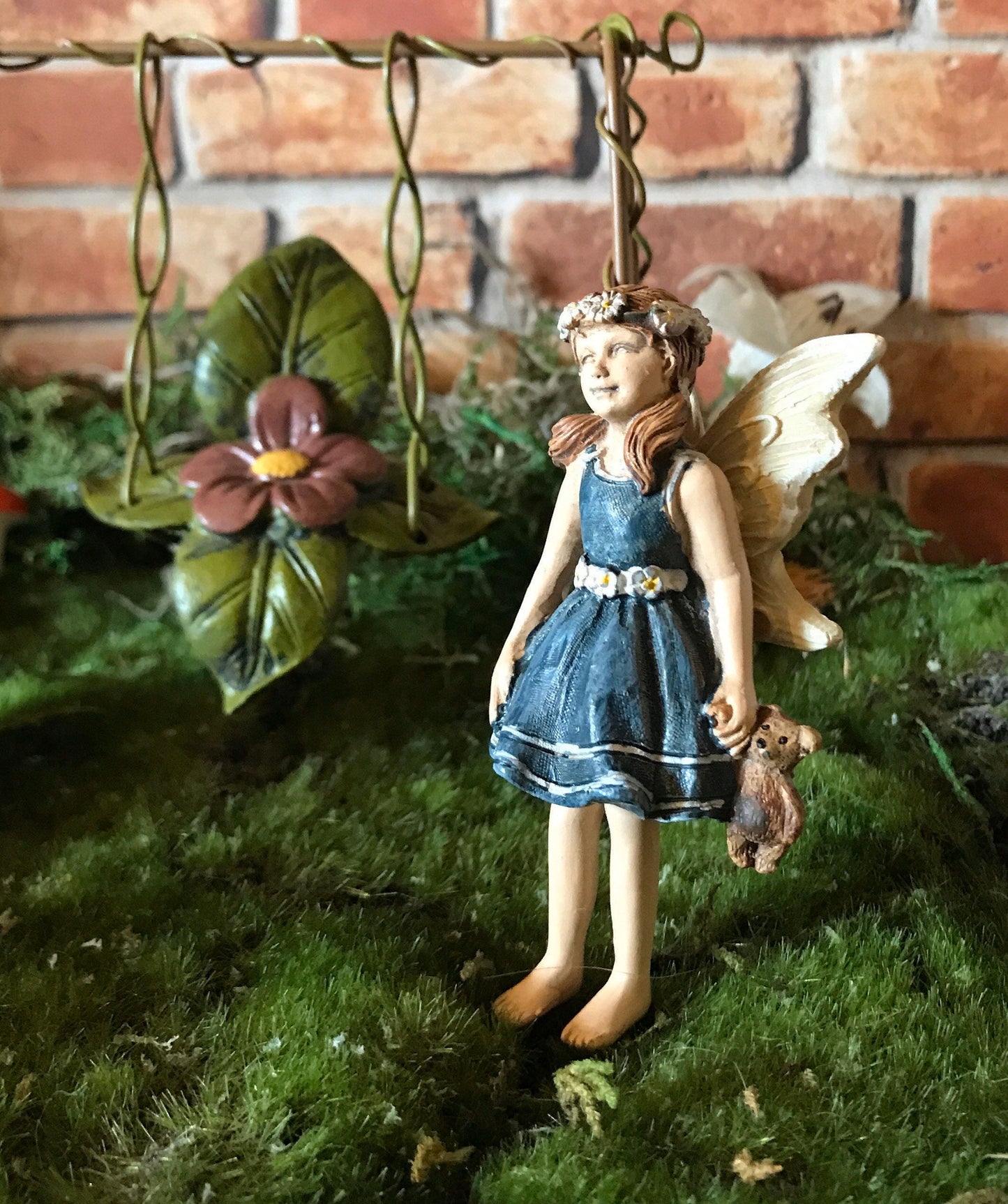 Sweet fairy girl with teddy bear toy
