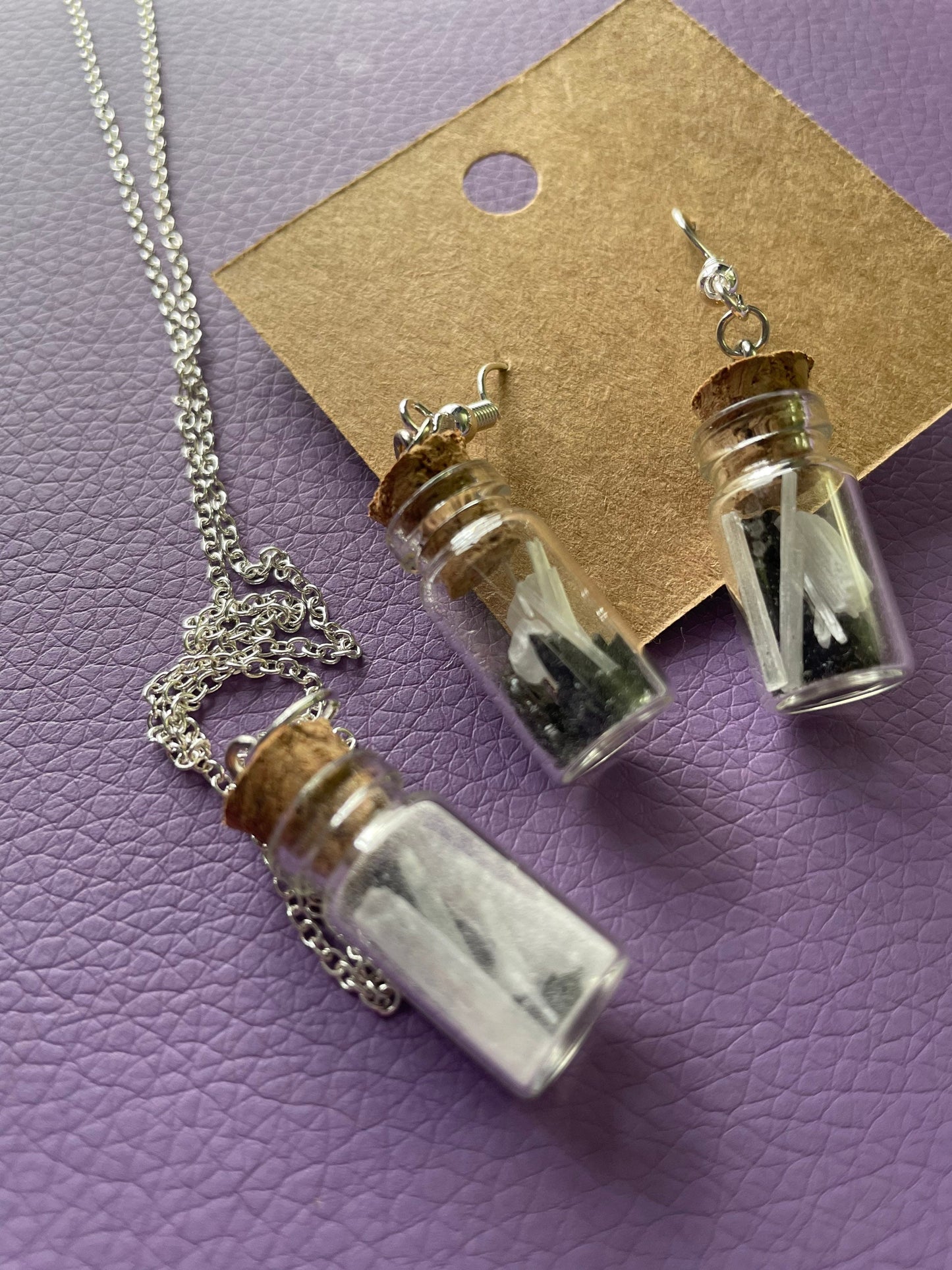Small bottle earrings and/or necklace filled with a Powerful crystal protection.