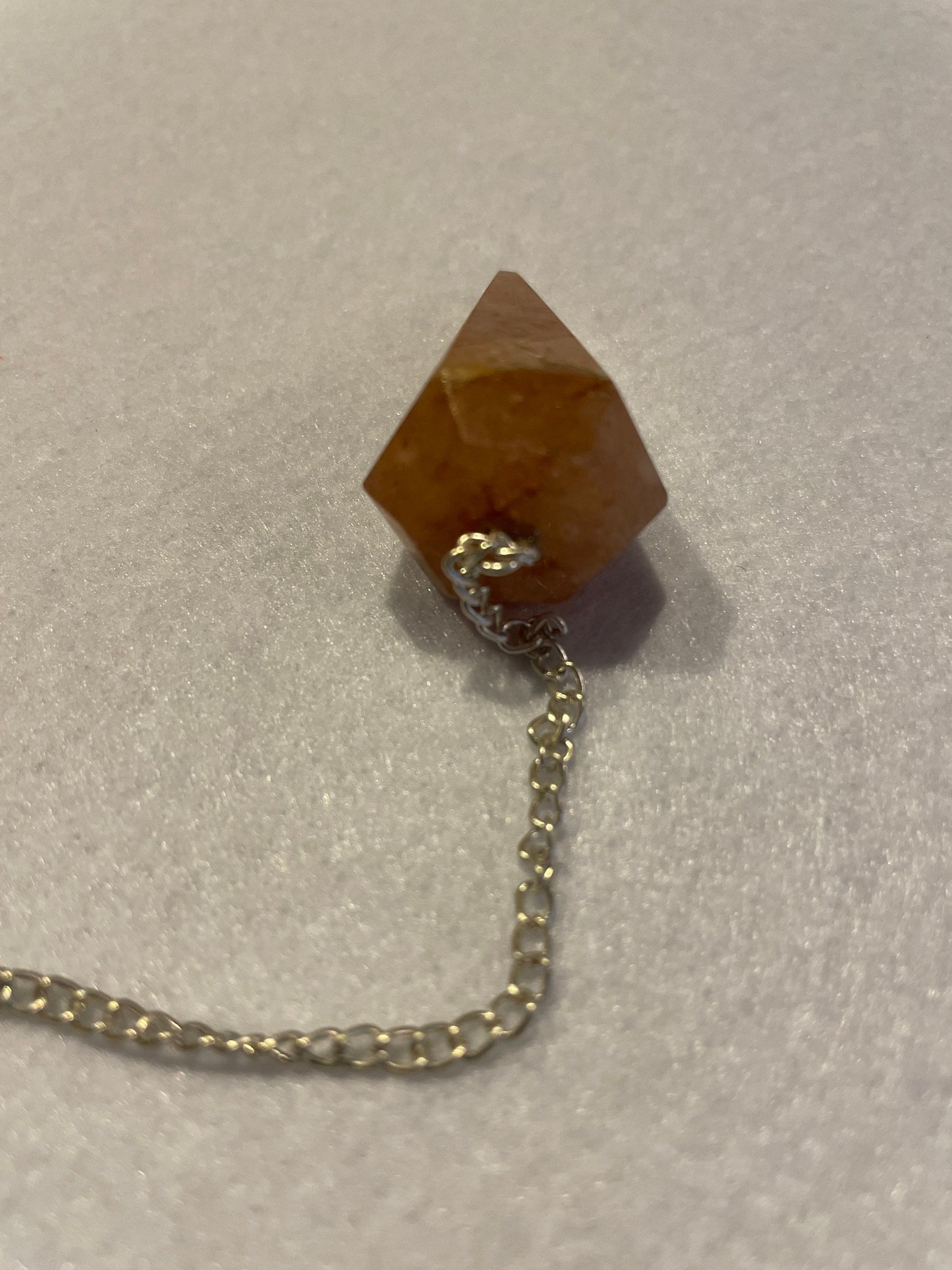 Beautiful Carnelian Pendulum is 1.25” and with the chain it is approximately 9.5”