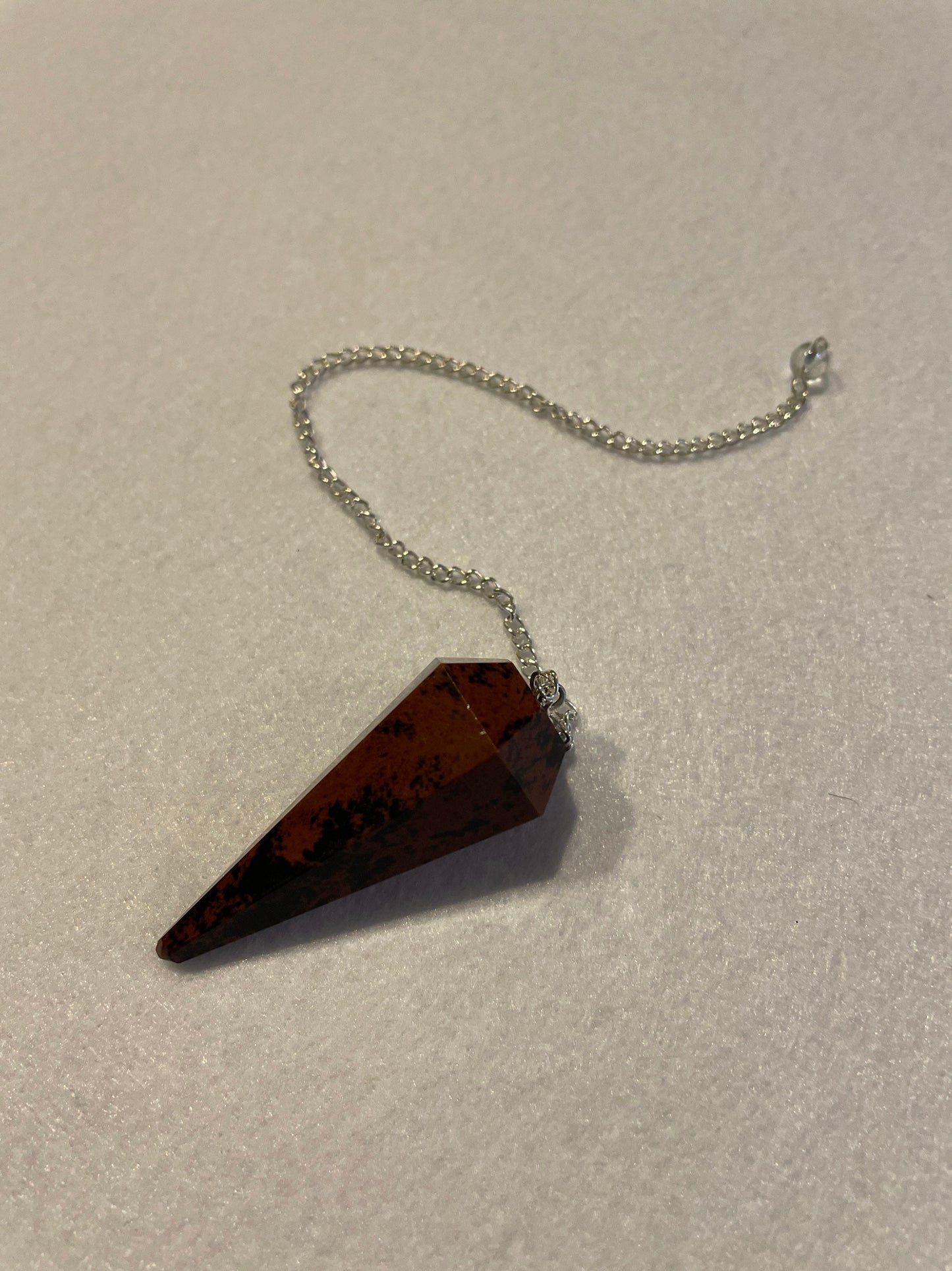 Beautiful Mahogany Obsidian Pendulum 2” stone with chain 9”.