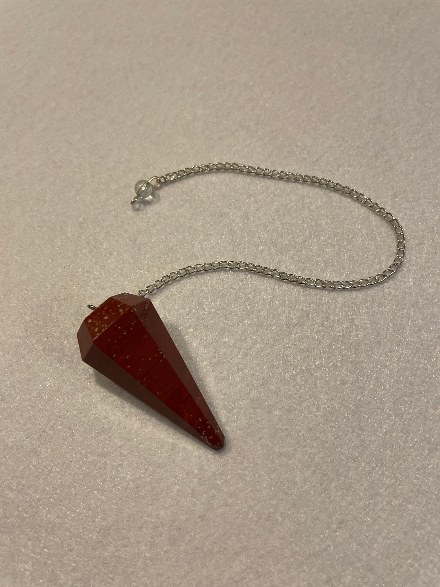 Beautiful Red Jasper Pendulum is 1.75” with chain 9.25”.