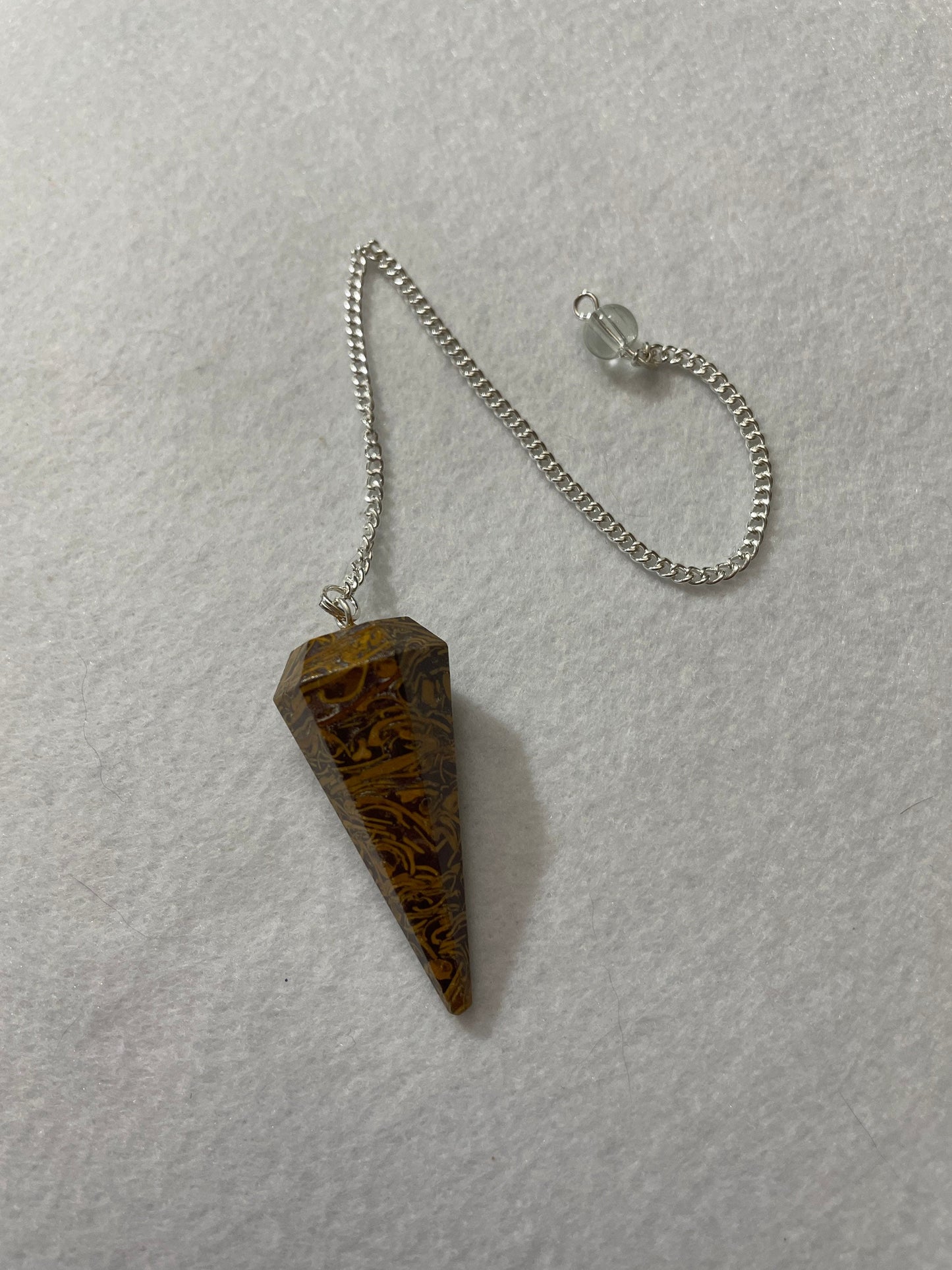 This Mariam Jasper Pendulum is  1.75” and with the chain is 8.5”.