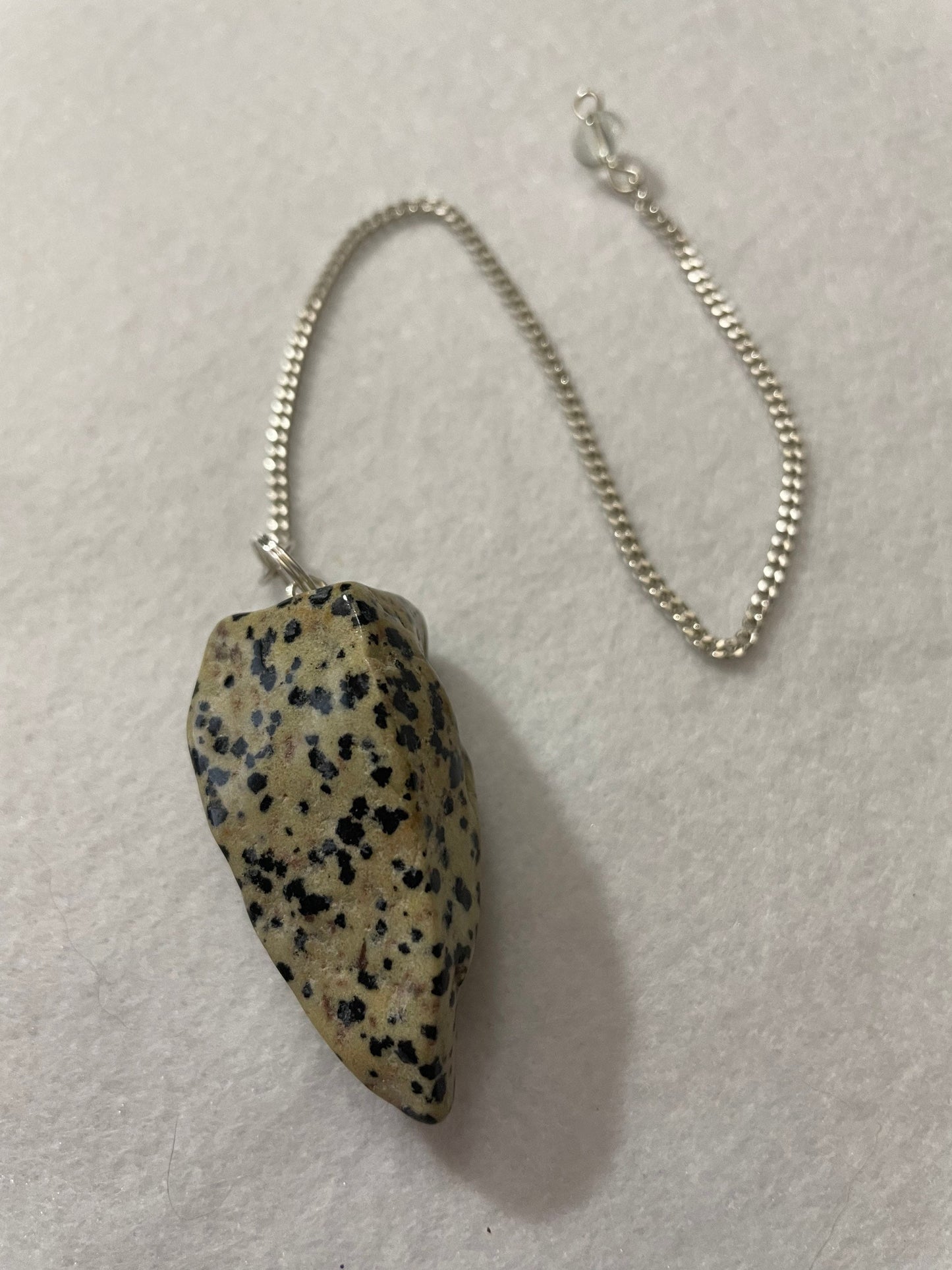 This Dalmatian Jasper Pendulum is  1.75” and with the chain is 9.5”