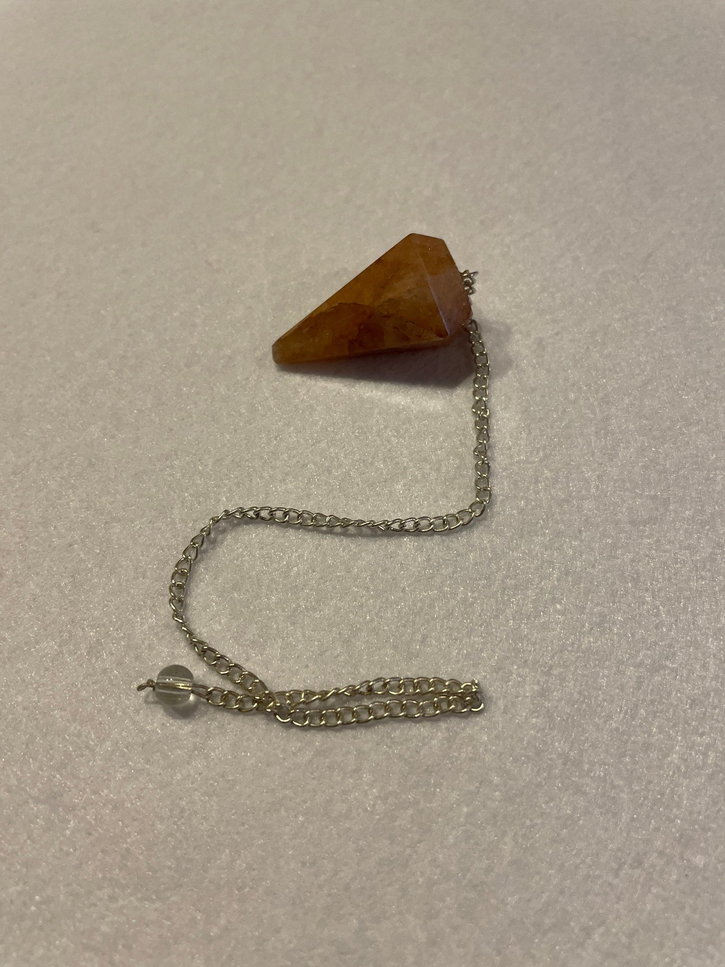 Beautiful Carnelian Pendulum is 1.25” and with the chain it is approximately 9.5”