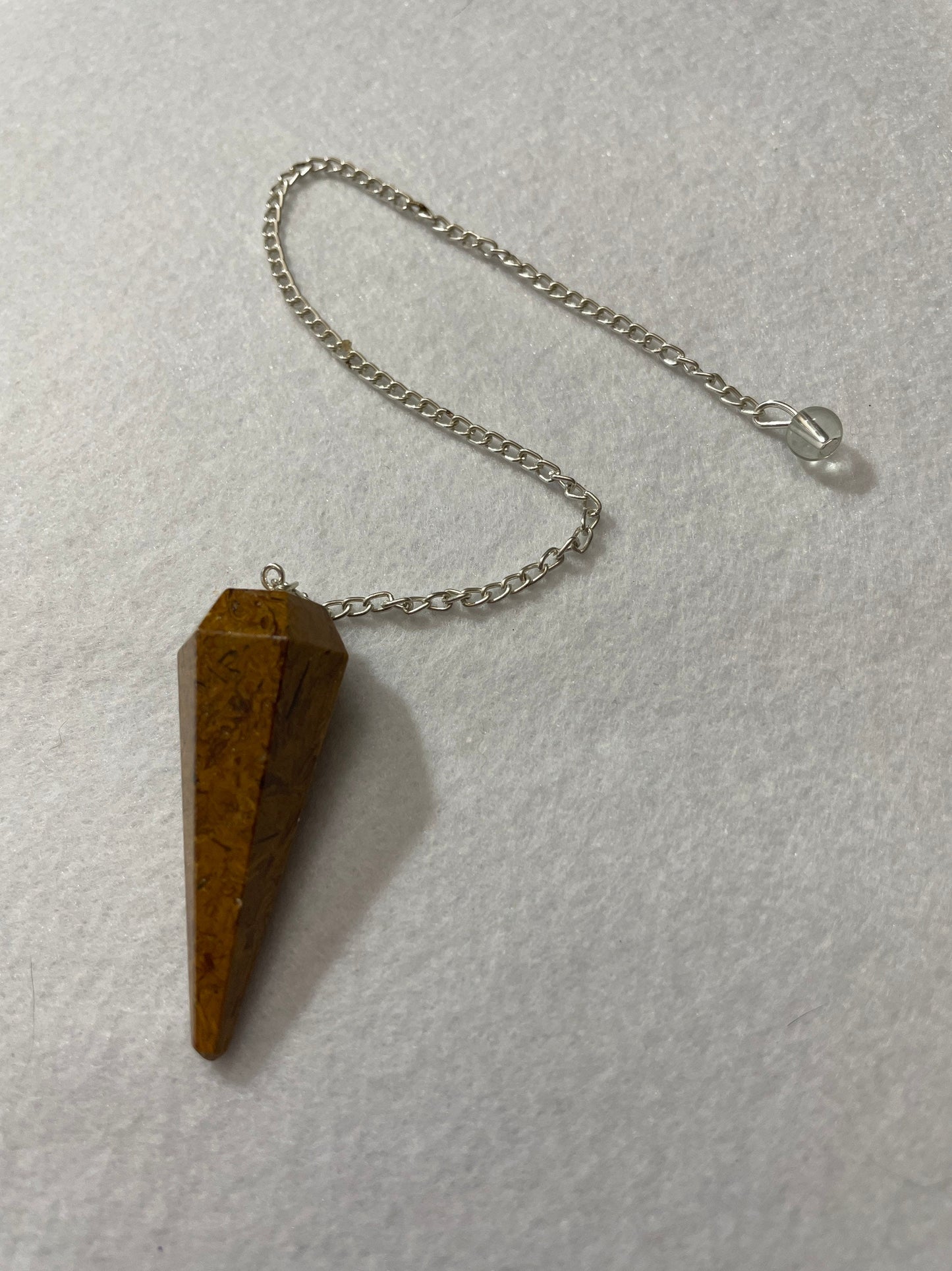 This beautiful Yellow Jasper Pendulum is 1.75” with the chain it is approximately 10.5”.