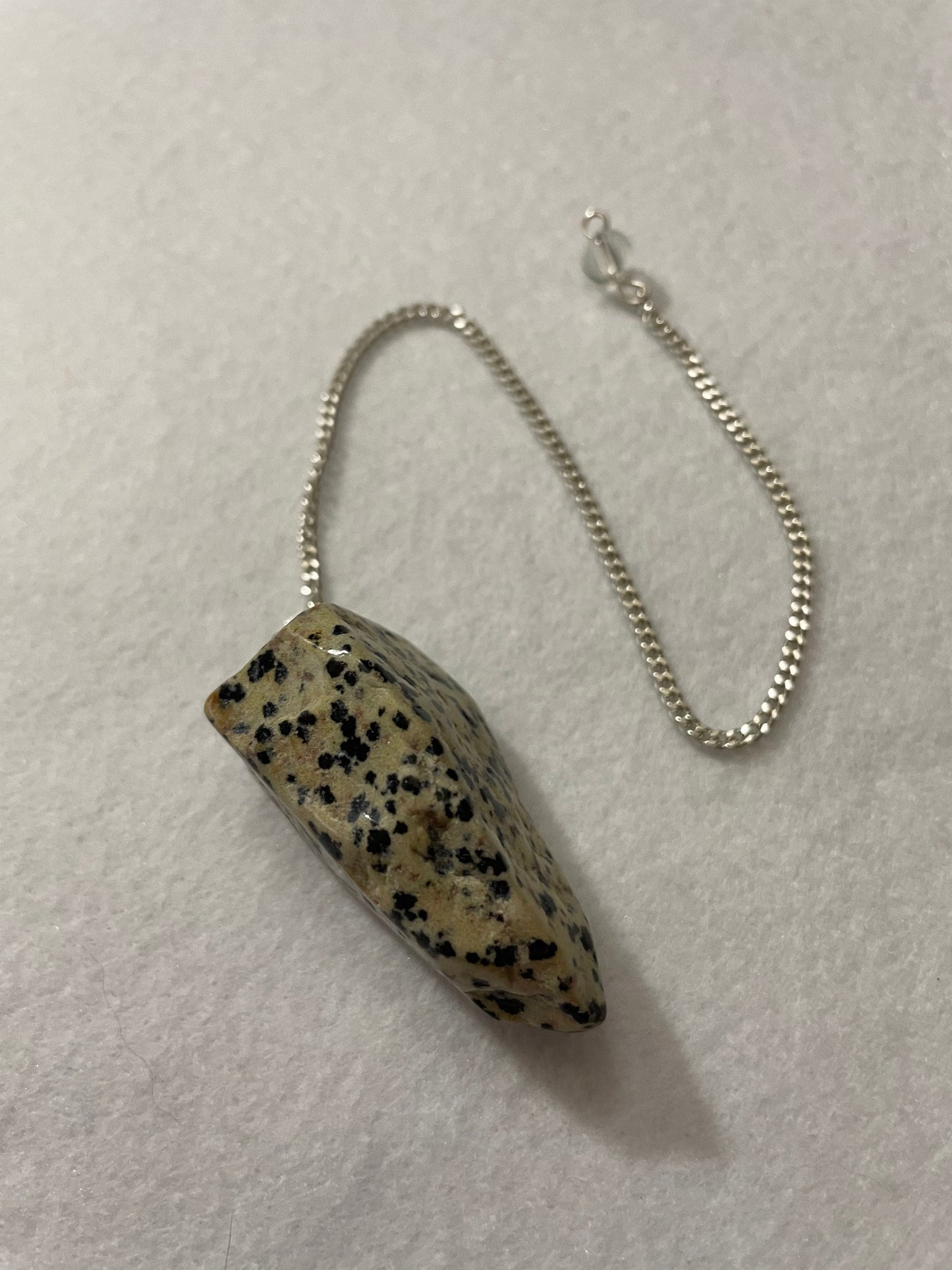 This Dalmatian Jasper Pendulum is  1.75” and with the chain is 9.5”