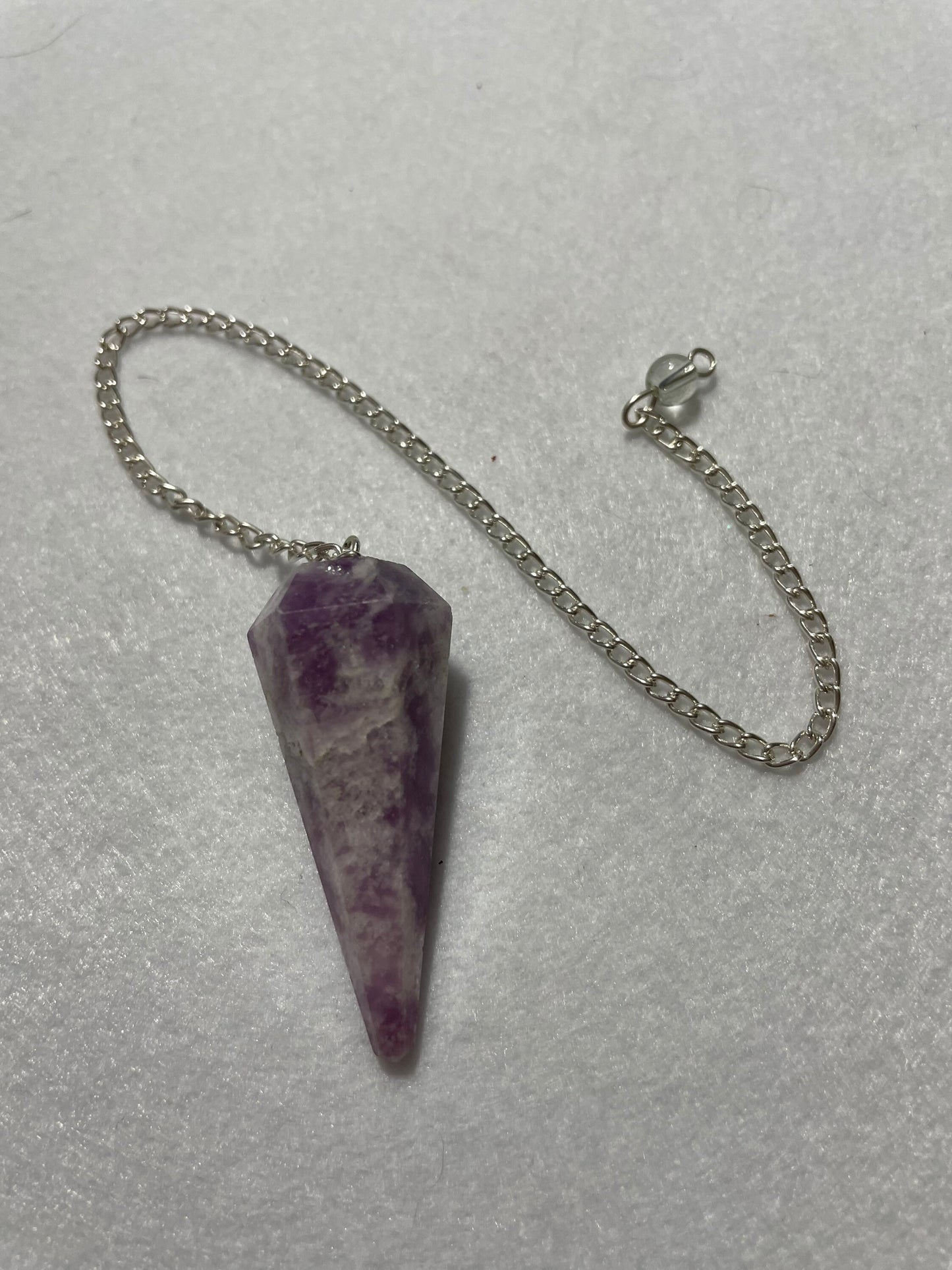 Beautiful Lepidolite Pendulum is  1.75” and with chain is 9”.