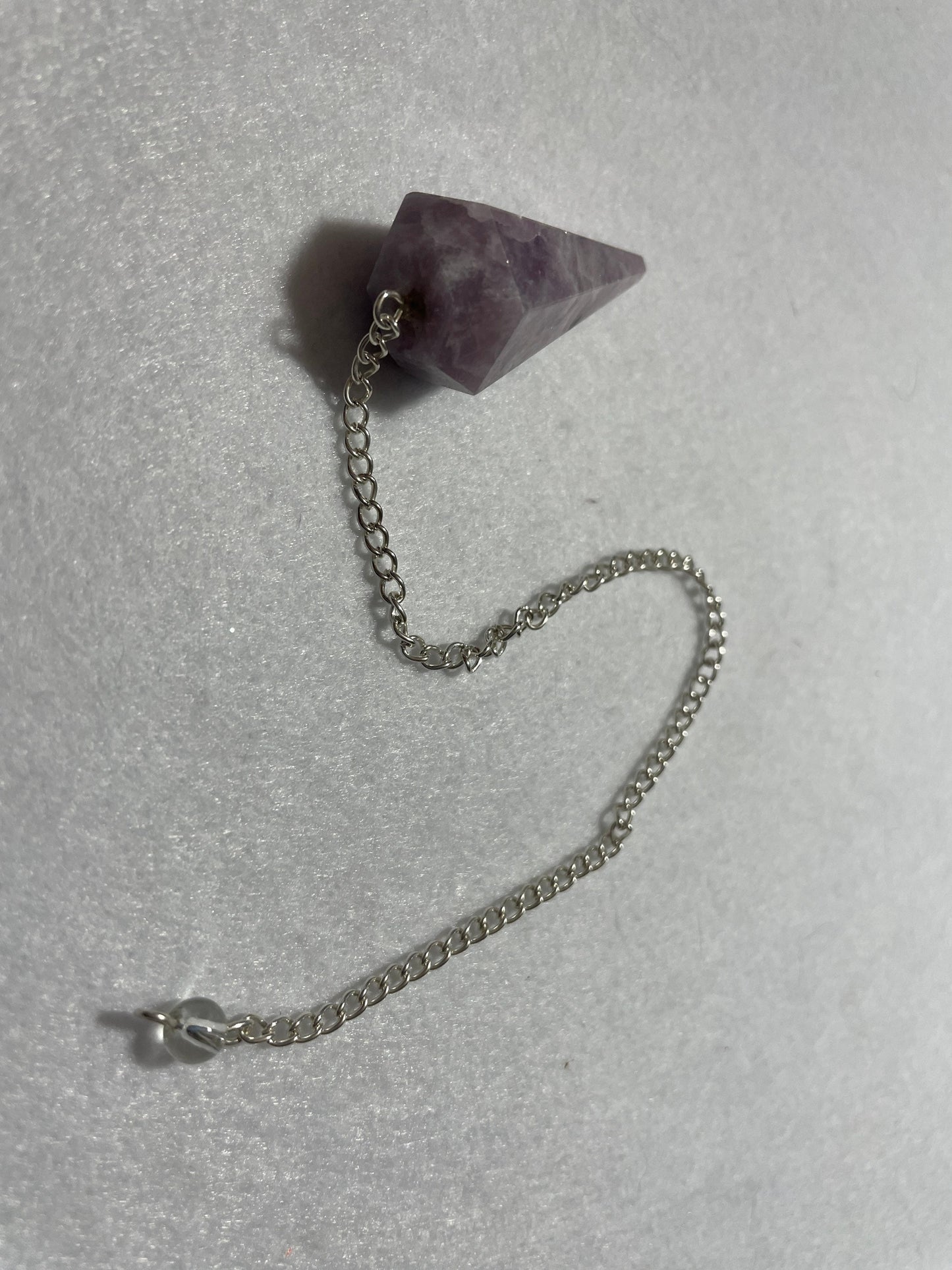 This beautiful Lepidolite Pendulum is  1.65” and with chain is 9”