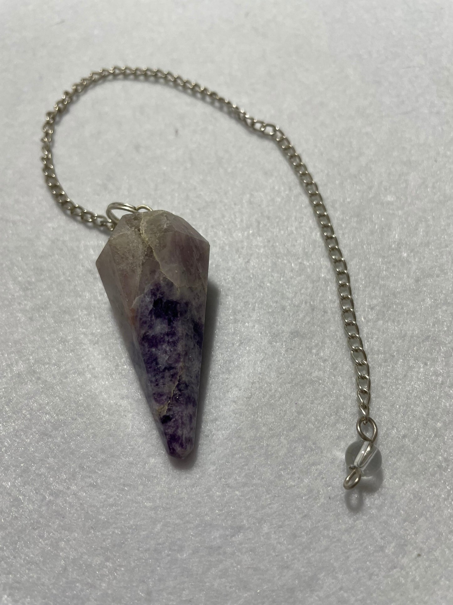 This pretty pink and purple Lepidolite Pendulum is  1.65” and with chain is 9”