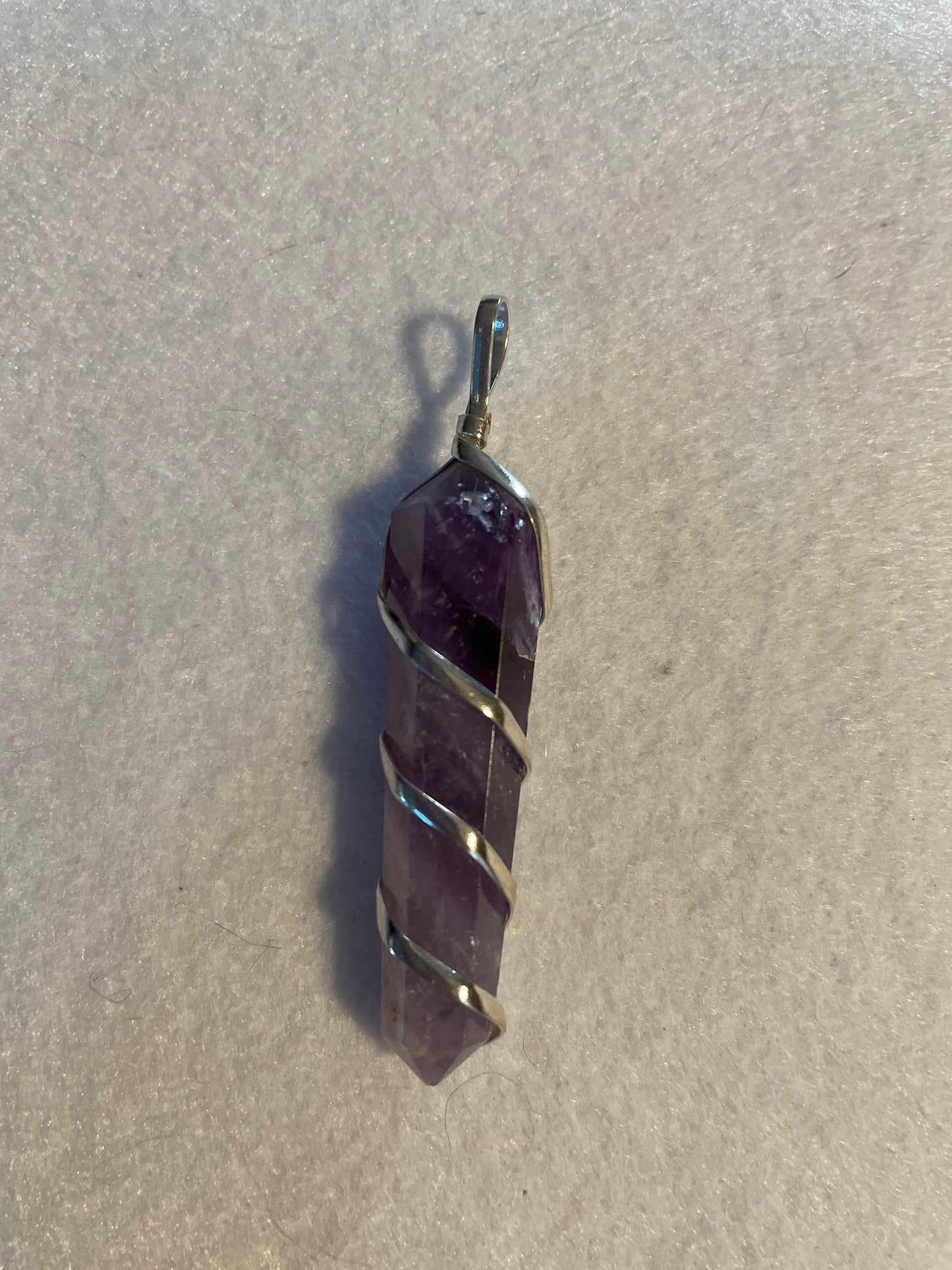 Gorgeous Amethyst point Pendant is almost 2” and is wrapped in precious silver.