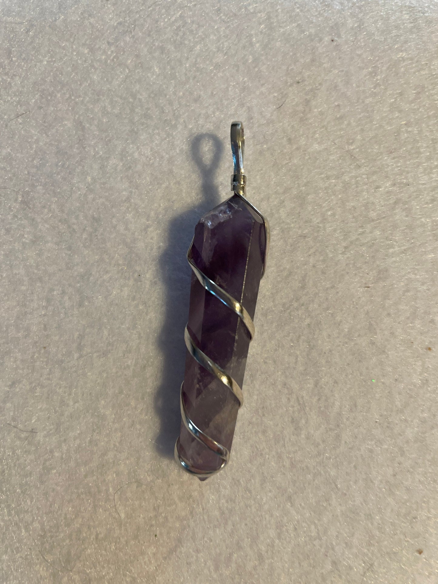 Gorgeous Amethyst point Pendant is almost 2” and is wrapped in precious silver.