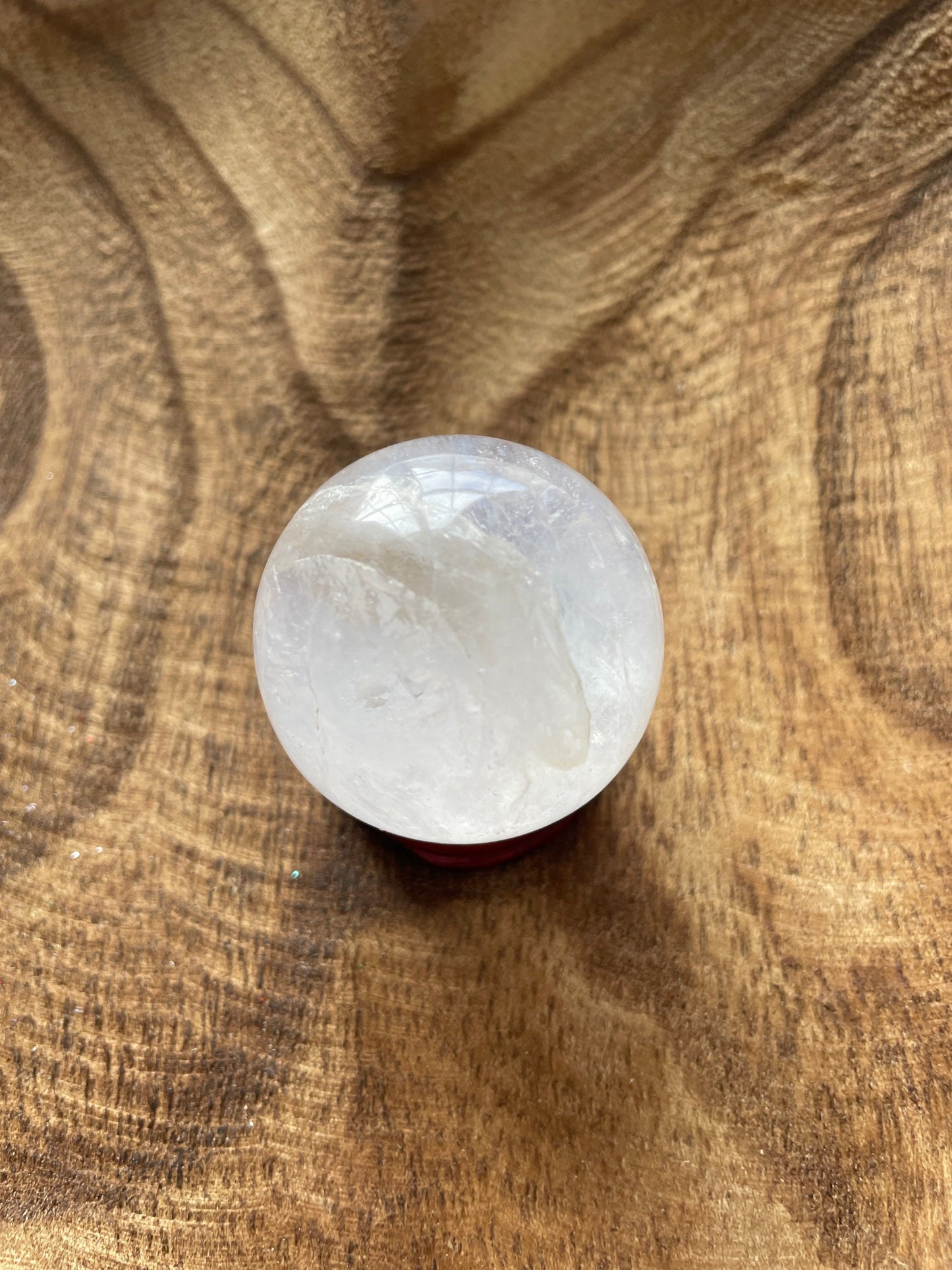 Crystal Clear Quartz crystal ball/sphere is 3.2 oz with the wooden stand.