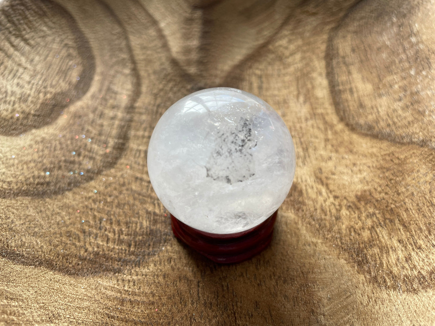 Crystal Clear Quartz crystal ball/sphere is 3.2 oz with the wooden stand.