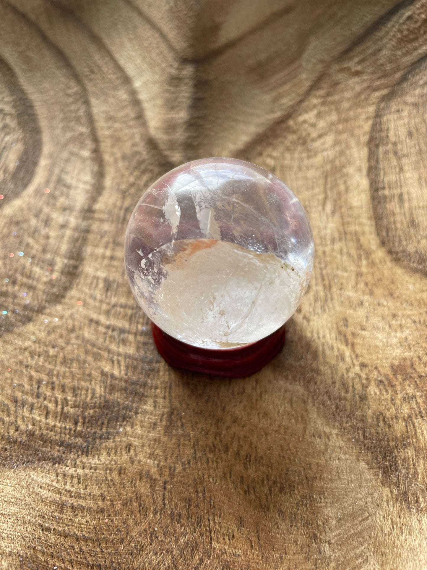 Crystal Clear Quartz crystal ball/sphere is 3.4 oz with the wooden stand.