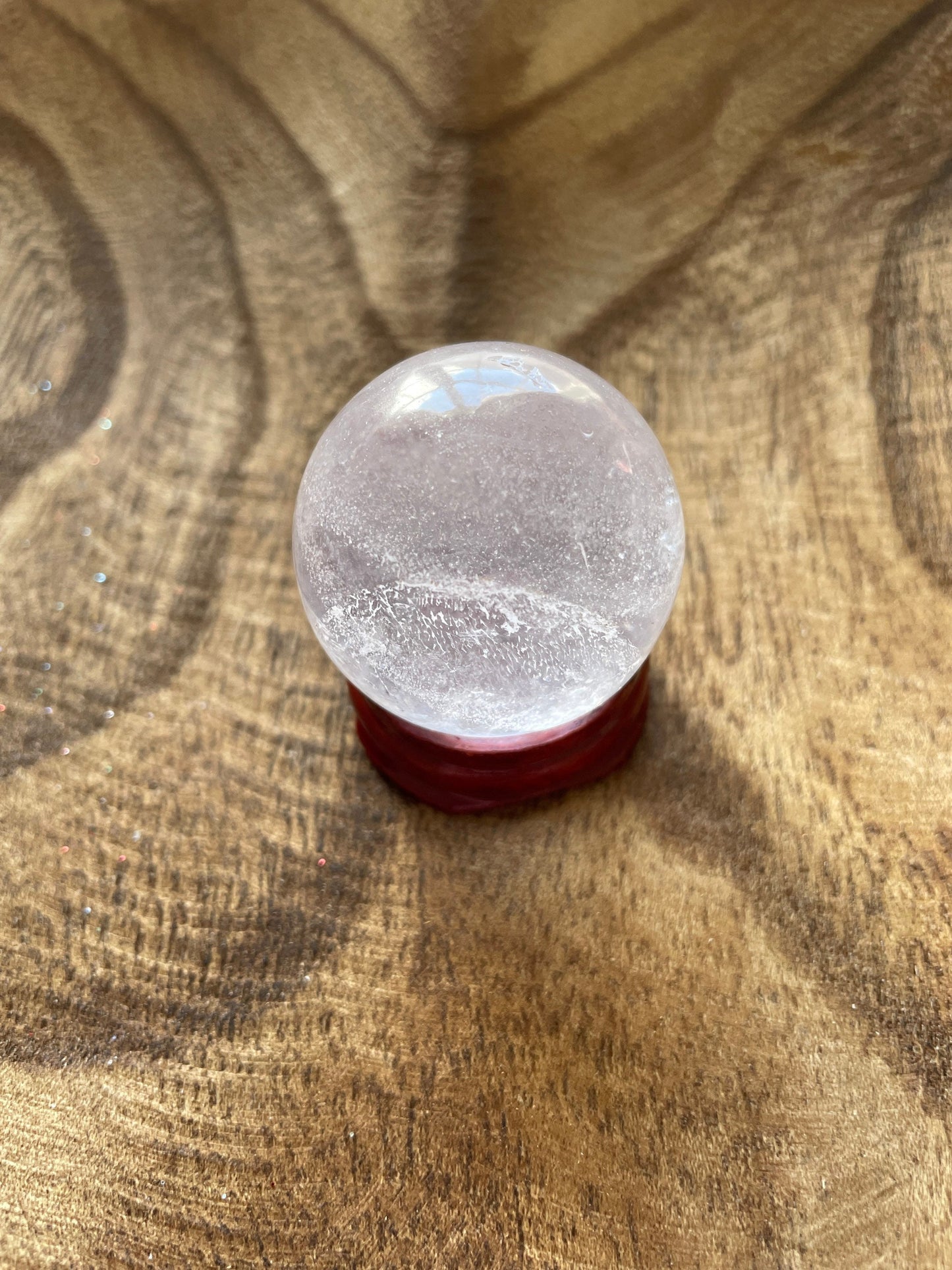 Crystal Clear Quartz crystal ball/sphere is 2.7 oz with the wooden stand.